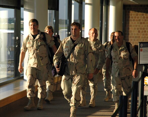 Reserve aerial porters assigned to the 315th Airlift Wing at Charleston AFB, S.C., arrives at the Charleston International Airport where family members wait to welcome them home.  The aerial porters are a part of the 53 Airmen returning from a 4-month deployment in Kuwait.  (Photo by 1st Lt. Wayne Capps)