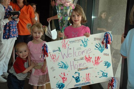 The grand children of Master Sgt. Sheryl Blackwell wait patiently on the grandmother’s arrival at the Charleston International Airport.  Sergeant Blackwell, a reservist assigned to the 81st Aerial Port Squadron, was one of the 53 Airmen returning from a 4-month deployment in Kuwait.  (Photo by 1st Lt. Wayne Capps)