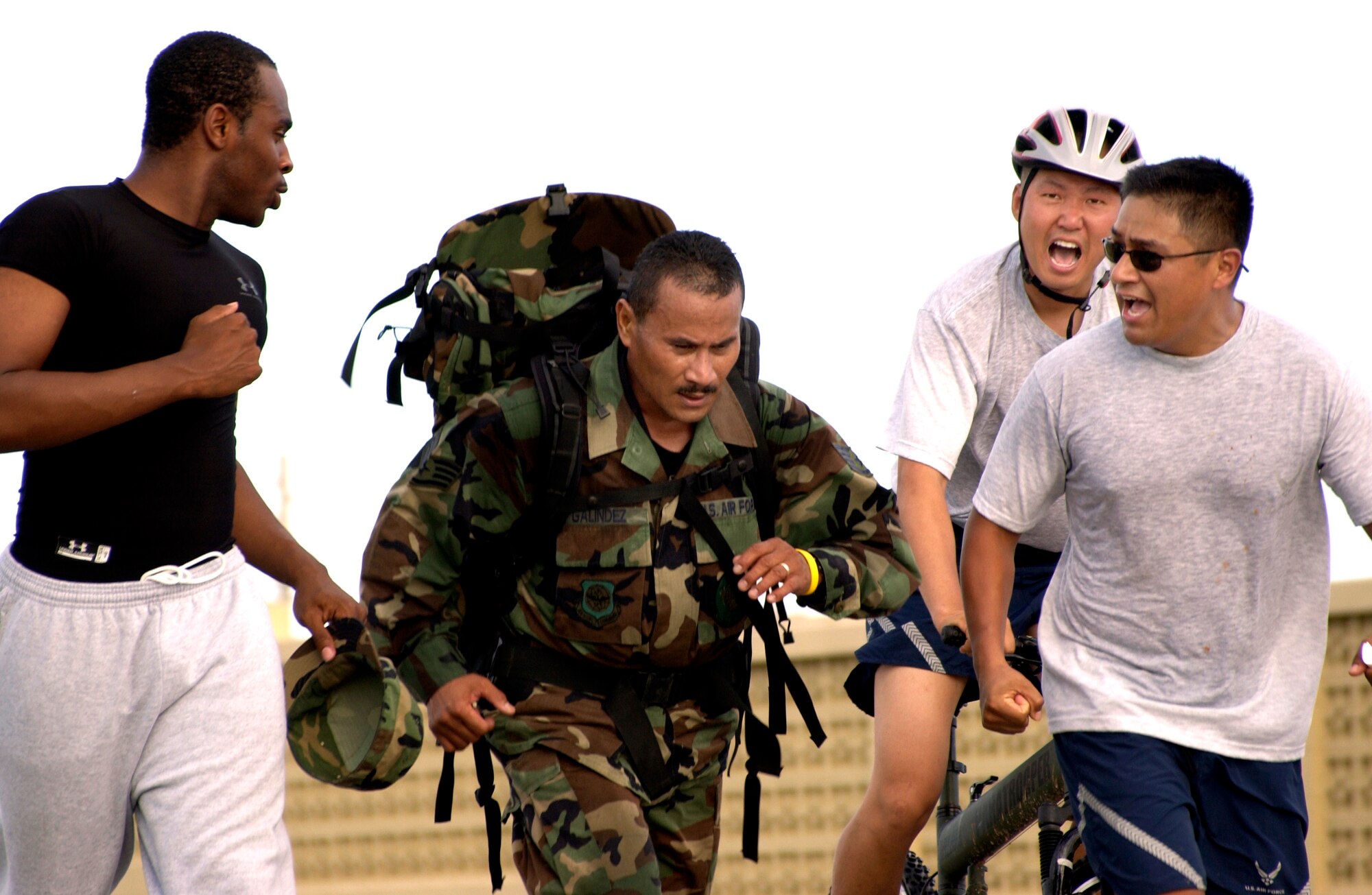 Staff Sgt .Sinforoso Galindez is cheered on by his teammates while he competes in the ruck sack portion of the Quadathlon held during National Police Week on Tuesday, May 16, 2006, at Andersen Air Force Base, Guam.  National Police Week (May 13-20, 2006) is being hosted by the 36th Security Forces Squadron. (U.S. Air Force photo/Miranda Moorer) 