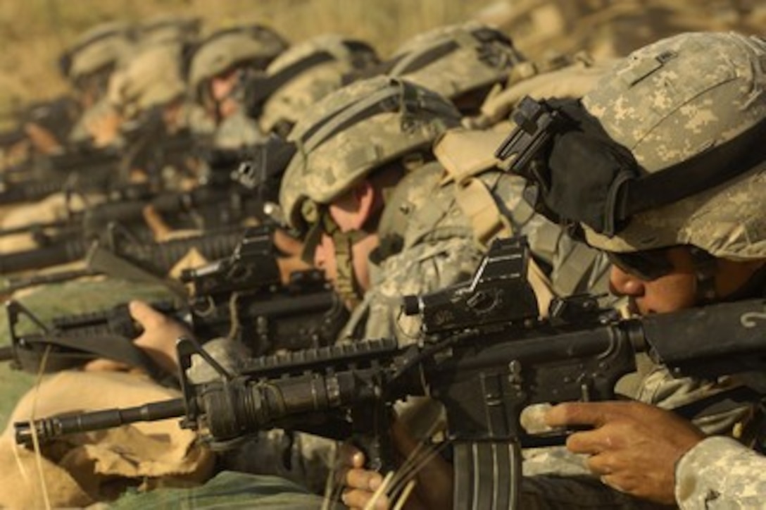 U.S. Army soldiers from the 1st Armored Division sight in their weapons at a firing range near Tall Afar, Iraq, on May 13, 2006. 