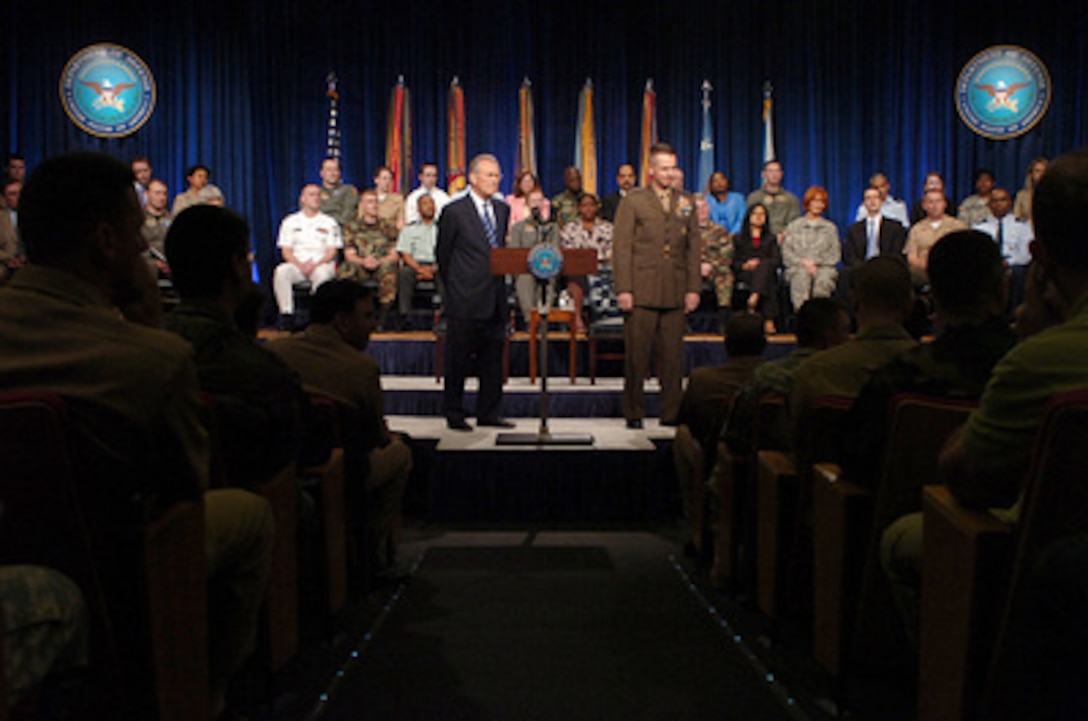 Secretary of Defense Donald H. Rumsfeld and Chairman of the Joint Chiefs of Staff Gen. Peter Pace, U.S. Marine Corps, address Pentagon civilian employees and service members during a town hall meeting on May 19, 2006. Rumsfeld and Pace answered questions and thanked the audience for their hard work and devotion. 