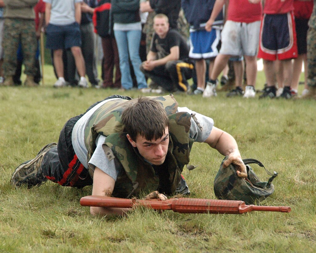 A Recruiting Station Portsmouth poolee, low crawls during a combat relay race at the RS Portsmouth annual Field Meet May 20 at the Portsmouth Naval Shipyard. Approximately 450 poolees and their guests attended the event designed to instill camaraderie and esprit de corps as well as ensure the RS summer pool was ready to ship to recruit training.