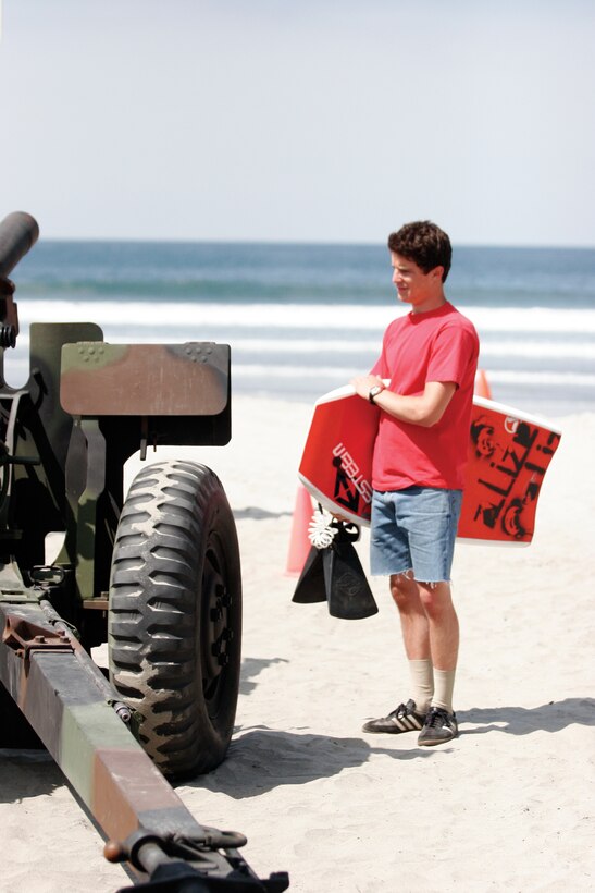 Chad Whitaker, an 18-year-old from Pismo Beach, checks out a 105 mm Howitzer after surfing in a local tournament within walking distance down the beach. Thousands of civilians had the chance to see military life up close Saturday.