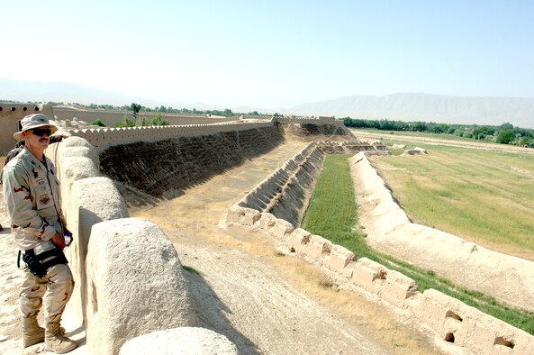 Col. Mike Wilson looks over the mud wall of Kala-I Janghi near Mazar-I-Sharif, Afghanistan.  The ancient fortress was the site of a bloody Taliban uprising in 2001.   Colonel Wilson is deployed to Kabul, Afghanistan.   (U.S. Air Force photo/Master Sgt. Orville F. Desjarlais Jr.)