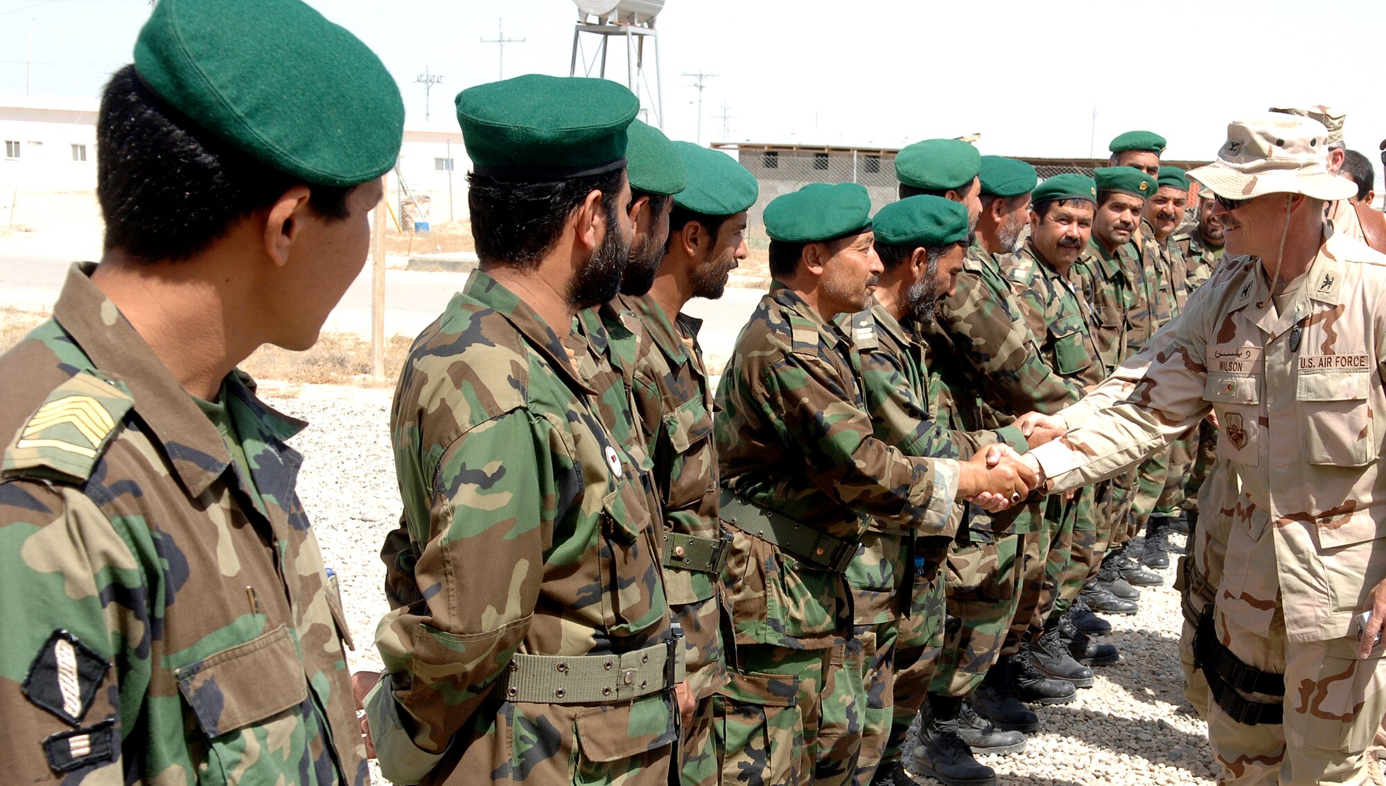 Col. Mike Wilson, Detachment 2 commander deployed to Kabul, Afghanistan, is welcomed by Afghan National Army soldiers during a recent site visit. Airmen on embedded training teams are training ANA troops about supply issues. (U.S. Air Force photo/Master Sgt. Orville F. Desjarlais)