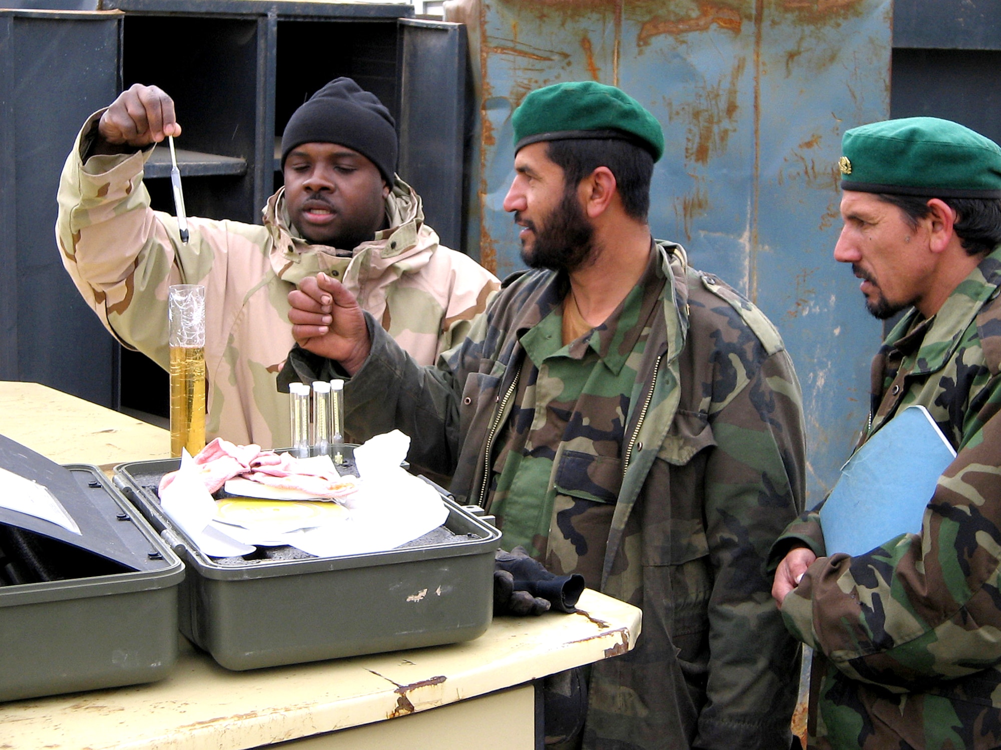 Tech. Sgt. Roland Alexander teaches Afghan National Army soldiers how to test fuel.  Airmen on embedded training teams are training ANA troops about supply issues. (U.S. Air Force photo/Master Sgt. Orville F. Desjarlais)