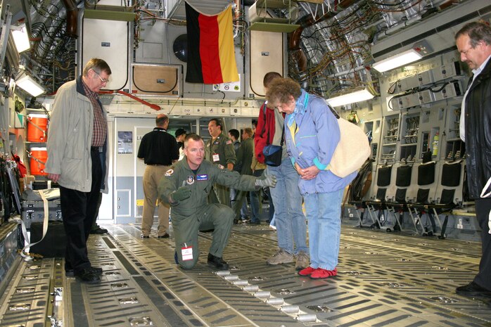 Maj. Dave McDonald demonstrates how cargo can be rolled onto the C-17 Globemaster III during the Berlin Air Show on May 19, 2006, at the Berlin-Schoenefeld Airport. Major McDonald is a 315th Airlift Wing pilot from Charleston Air Force Base, S.C. From May 19 to 21, 120,000 people visited the air show, which promoted the goals of enhancing interoperability among U.S. allies as well as the commitment to the preservation of Europe's security. (U.S Air Force photo/Maj. Pamela A.Q. Cook)