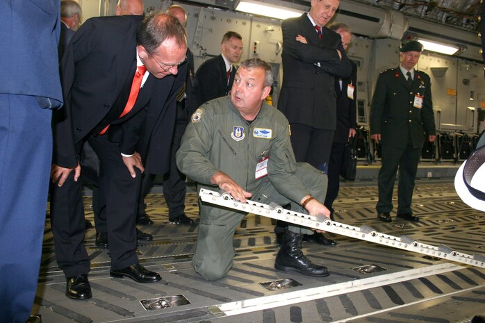 Col. Gary Cook discusses the cargo load capabilities of the C-17 Globemaster III with the Dutch Minister of Defense, Henk Kamp, during the Berlin Air Show on May 18, 2006 at the Berlin-Schoenefeld Airport. Colonel Cook is the 315th Airlift Wing commander from Charleston Air Force Base, S.C. From May 19 to 21, 120,000 people visited the air show, which promoted the goals of enhancing interoperability among U.S. allies as well as the commitment to the preservation of Europe's security. (U.S Air Force photo/Maj. Pamela A.Q. Cook)