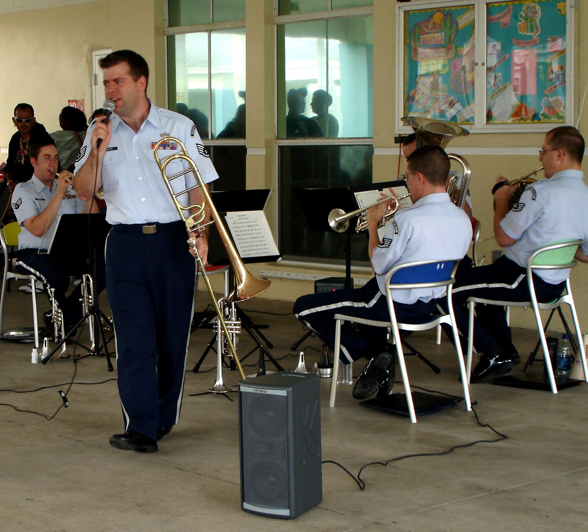 Staff Sgt. John Caputo belts out a James Brown tune during a concert at Community Partnership for Homeless in Homestead, Fla.  The band played a total of nine performances during a three day period in Miami-Dade County focused on thanking the community for their continued support of the Air Force Reserve.  Sergeant Caputo is a trombone player with the Band of the Air Force Reserve from Robins Air Force Base, Ga.  (U.S. Air Force photo/Tech. Sgt. Julie Briden-Garcia)