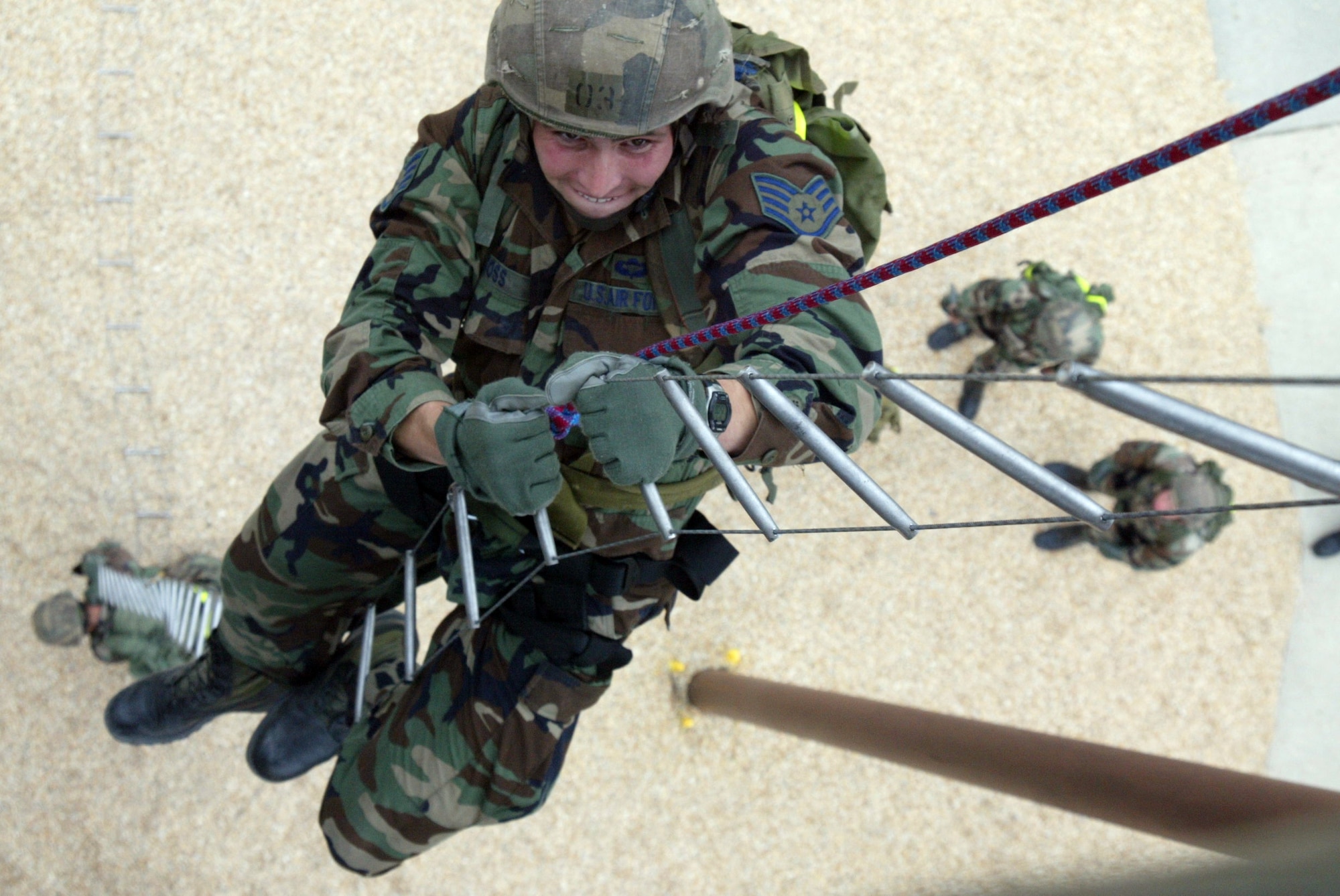 Staff Sgt. Matt Gross, 342nd Training Squadron, climbs 40-feet up a caving ladder at the Combat Control School tower at Pope Air Force Base, N.C. Students raced up both sides of the tower carrying at least 40 pounds of equipment. These students will use their training in the future when they support Naval units. The class is scheduled to graduate Thursday, June 22, after they complete three more blocks of training. (U.S. Air Force photo/Staff Sgt. Becky J. LaRaia)