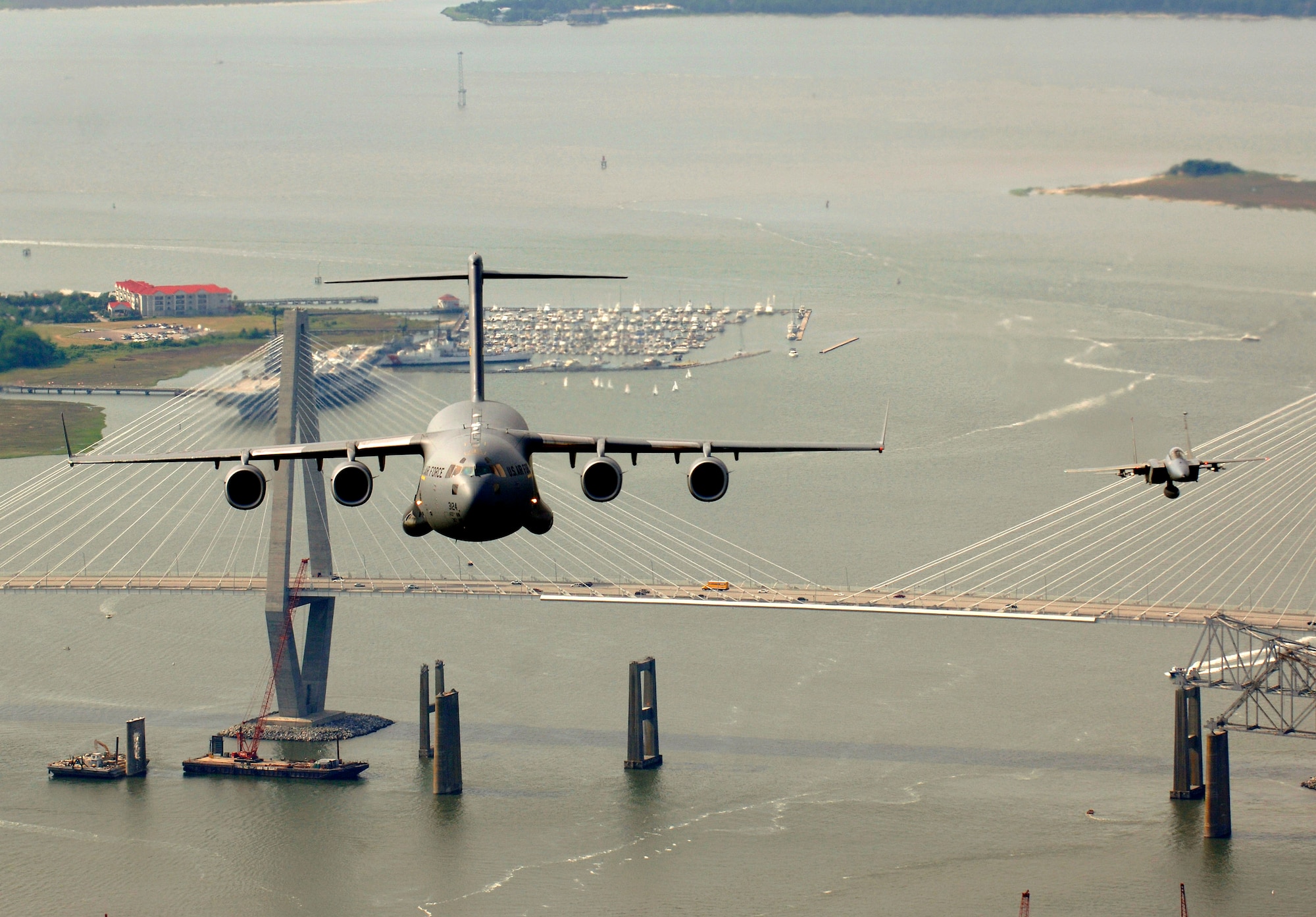 An F-15 Eagle from the 60th Fighter Squadron, Eglin Air Force Base , Fla., escorts a C-17 Globemaster III from the 14th Airlift Squadron, Charleston AFB, S.C., as they fly over the USS Yorktown and the Arthur J. Ravenel Jr. Bridge in the Charleston, S.C., area during a local training mission on Tuesday, May 16, 2006. (U.S. Air Force photo/Tech. Sgt. Russell E. Cooley IV)