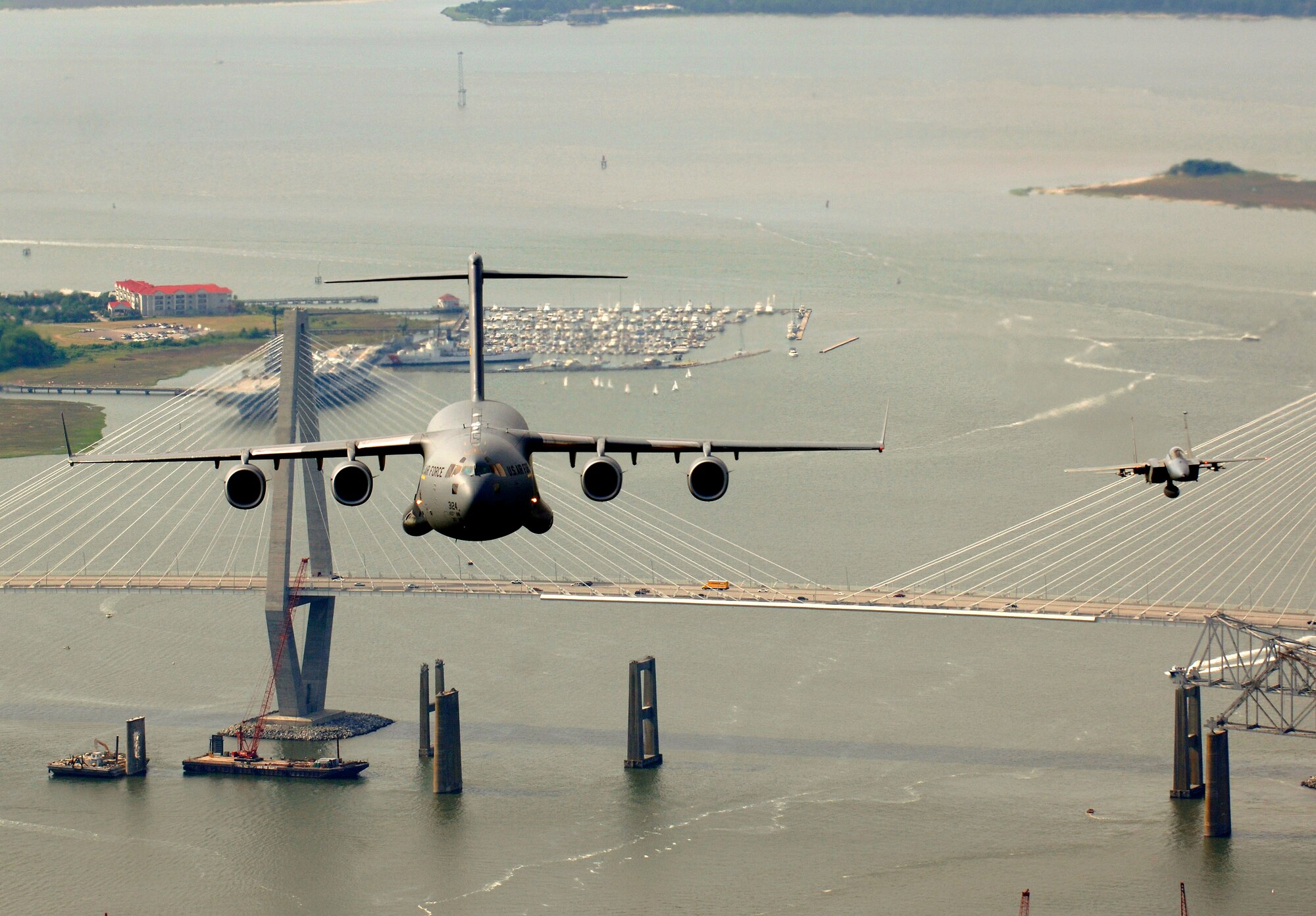 An F-15 Eagle from the 60th Fighter Squadron, Eglin Air Force Base , Fla., escorts a C-17 Globemaster III from the 14th Airlift Squadron, Charleston AFB, S.C., as they fly over the USS Yorktown and the Arthur J. Ravenel Jr. Bridge in the Charleston, S.C., area during a local training mission on Tuesday, May 16, 2006. (U.S. Air Force photo/Tech. Sgt. Russell E. Cooley IV)