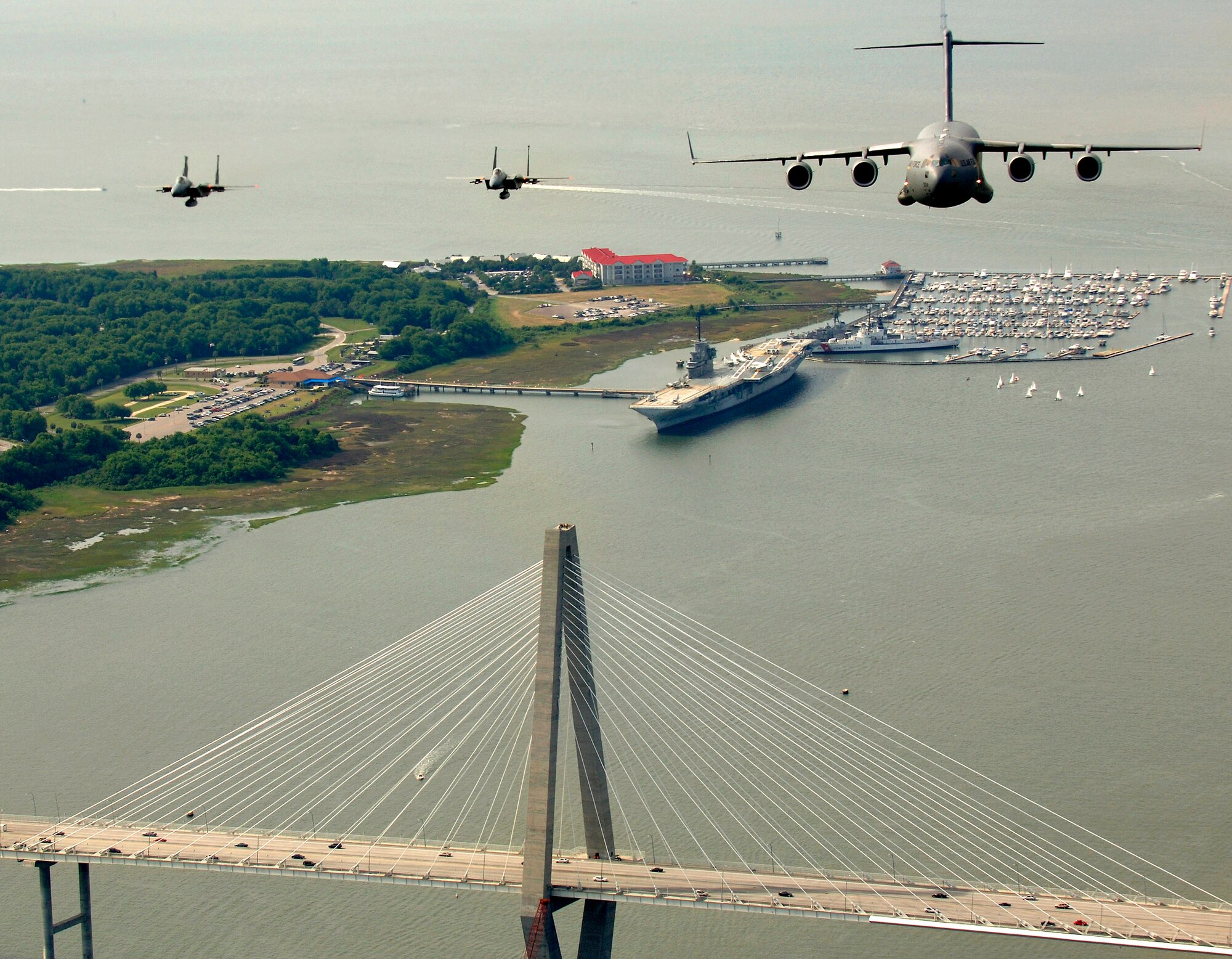 Two F-15 Eagles from the 60th Fighter Squadron, Eglin Air Force Base, Fla., escort a C-17 Globemaster III from the 14th Airlift Squadron, Charleston AFB, S.C., as they fly over the USS Yorktown and the Arthur J. Ravenel Jr. Bridge in the Charleston, S.C., area during a local training mission on Tuesday, May 16, 2006. (U.S. Air Force photo/Tech. Sgt. Russell E. Cooley IV)