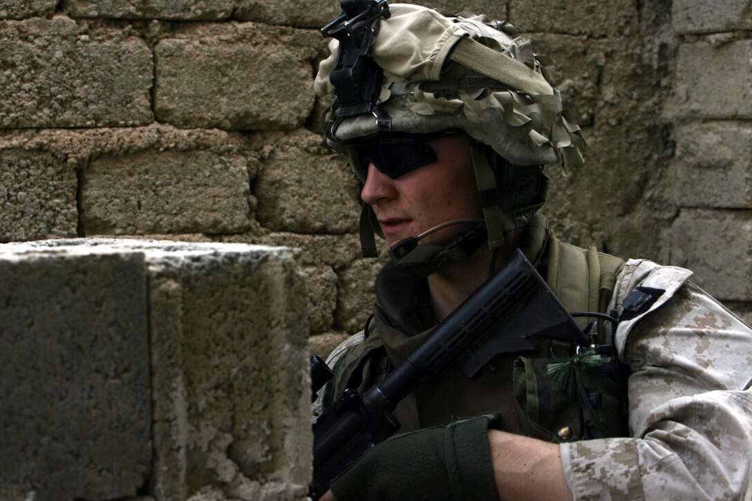 Corporal Timothy D. Roos, a 21-year-old squad leader from Cincinnati, Ohio, with 2nd Platoon, Weapons Company, 3rd Battalion, 8th Marine Regiment traverses through brick buildings during a patrol in Ar Ramadi on May 23. Weapons Company conducted a snap vehicle checkpoint patrol in downtown western Ramadi to disrupt insurgent activity in the battlespace. 3/8 is currently deployed with I Marine Expeditionary Force (Forward) in support of Operation Iraqi Freedom in Al Anbar Province to develop the Iraqi security forces, facilitate the development of official rule of law through democratic government reforms, and continue the development of a market-based economy centered on Iraqi reconstruction.