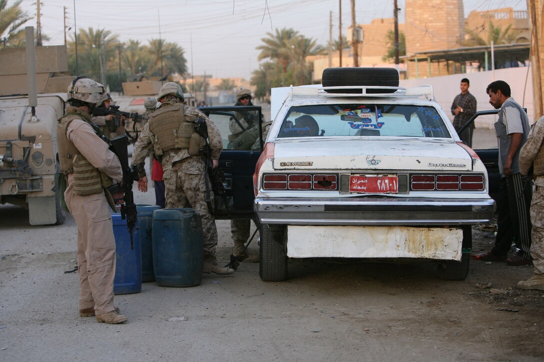 Marines with 2nd Platoon, Weapons Company, 3rd Battalion, 8th Marine Regiment search a vehicle during a mounted patrol May 23. They conducted a snap vehicle checkpoint patrol in downtown western Ramadi to disrupt insurgent activity in the battlespace. 3/8 is currently deployed with I Marine Expeditionary Force (Forward) in support of Operation Iraqi Freedom in Al Anbar Province to develop the Iraqi security forces, facilitate the development of official rule of law through democratic government reforms, and continue the development of a market-based economy centered on Iraqi reconstruction.