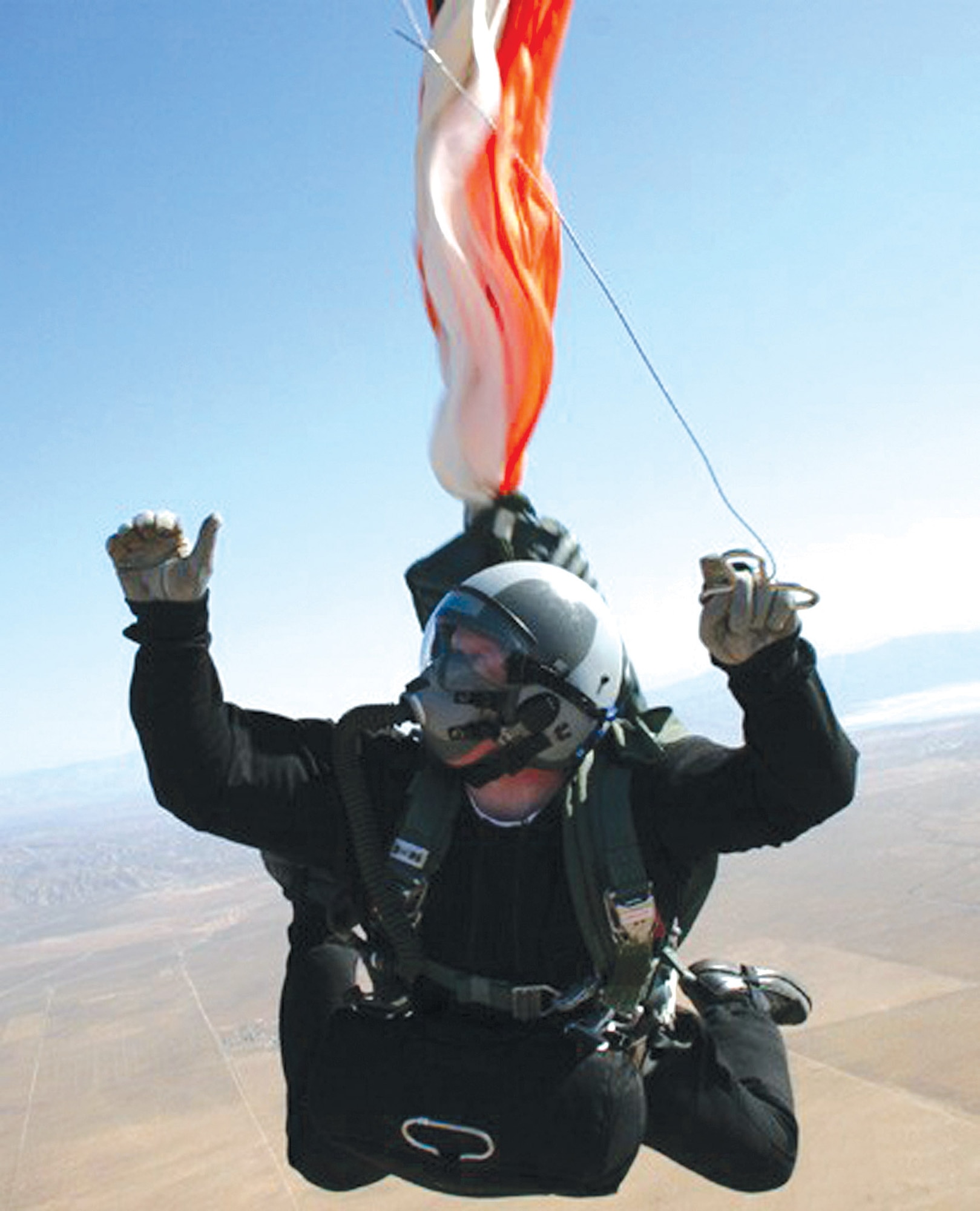 Staff Sgt. Scott Lawrence deploys his parachute during a practice jump over Edwards Air Force Base, Calif., on Tuesday, May 23, 2006.  He is assigned to the 418th Flight Test Squadron's test parachutist program.  (U.S. Air Force photo)