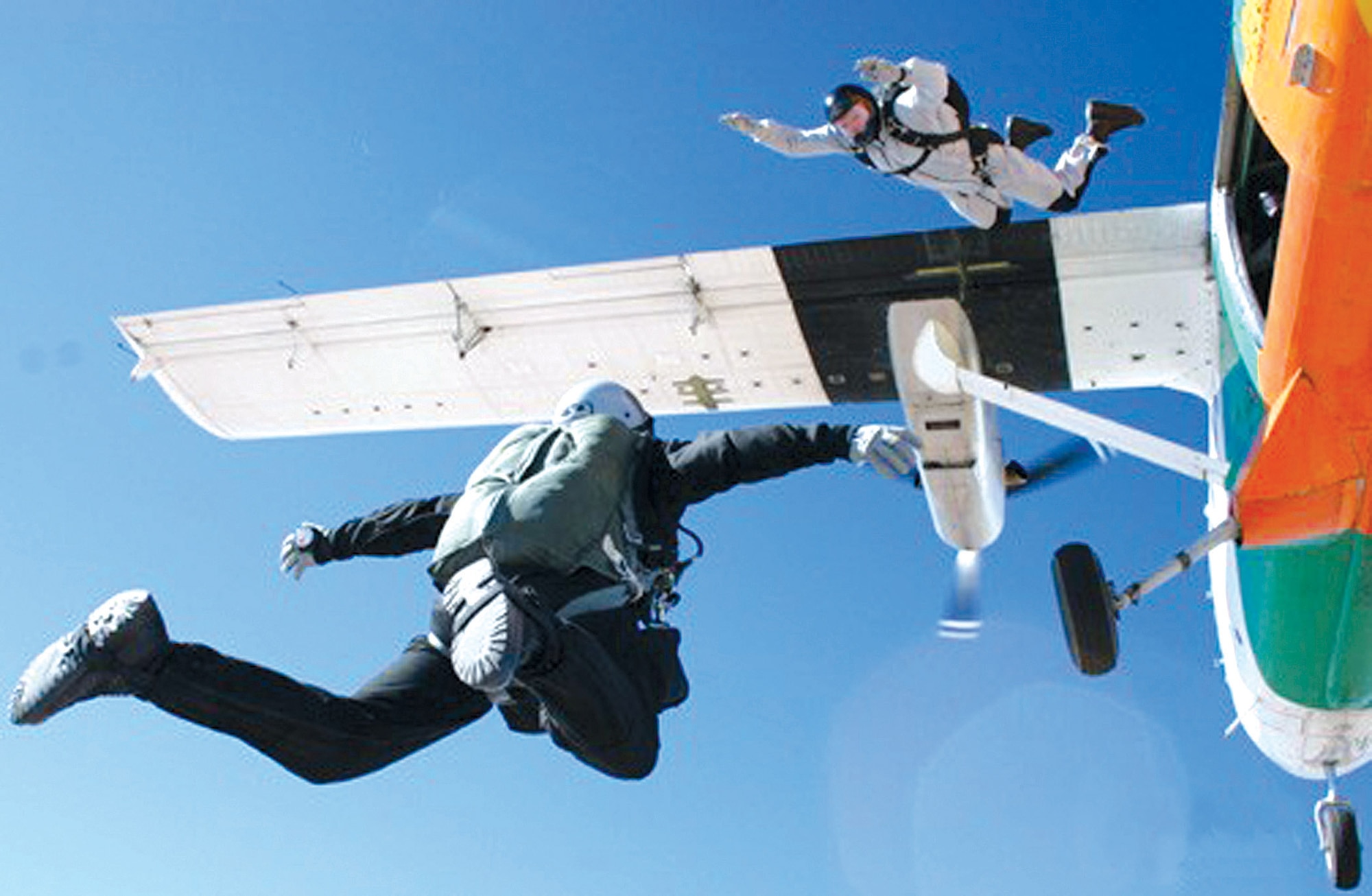 Tech. Sgt. Shawn Studer exits the plane to join Staff Sgt. Scott Lawrence in a freefall over Edwards Air Force Base, Calif., on Tuesday, May 23, 2006.  They are assigned to the 418th Flight Test Squadron's test parachutist program. (U.S. Air Force photo)