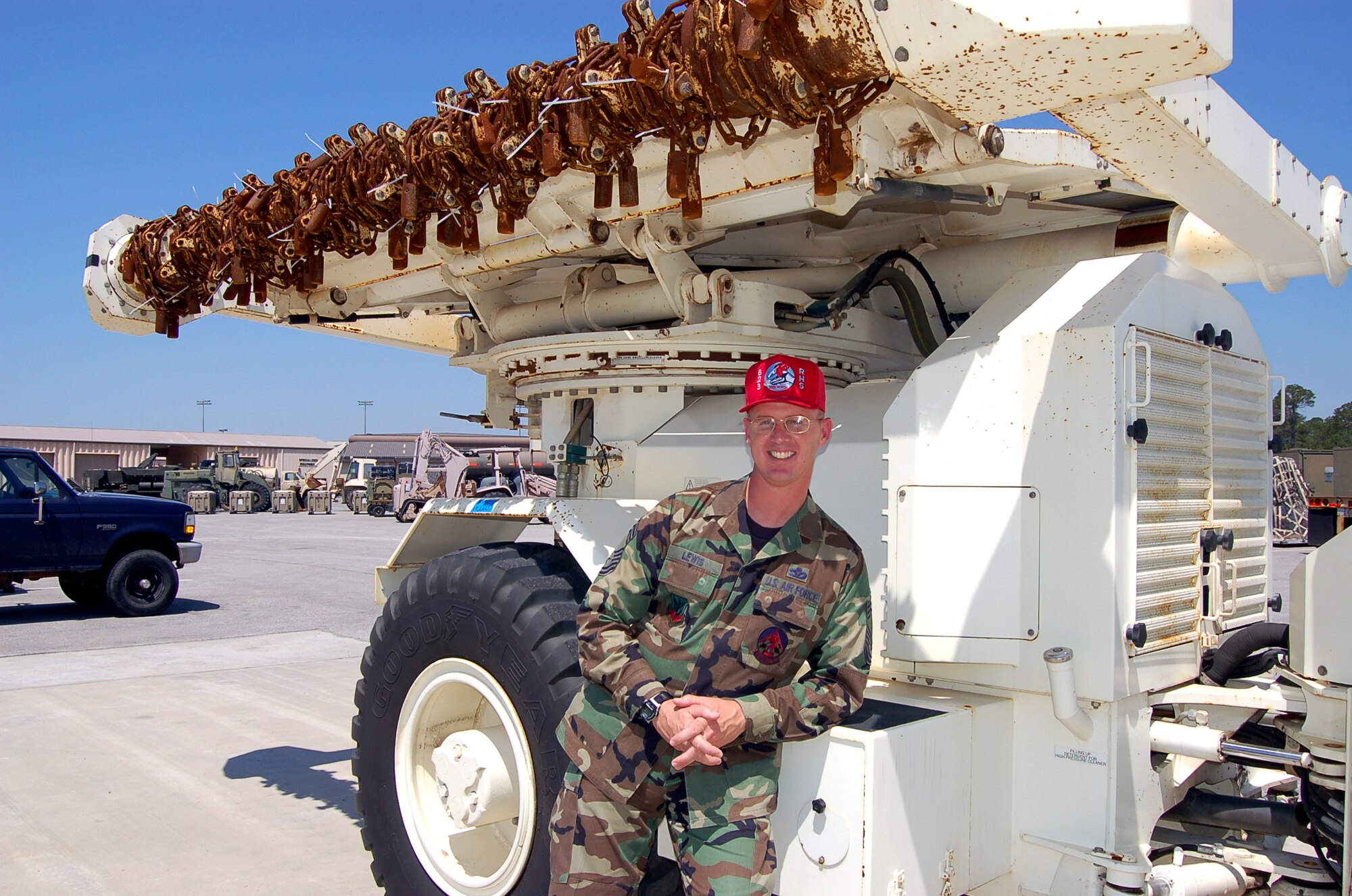 Chief Master Sgt. Mark Lewis shows off the Air Force's first robotic mine-area clearing vehicle at Hurlburt Field, Fla., on Tuesday, May 23, 2006. Developed by the 823rd Red Horse at Hurlburt and the Air Force Research Laboratory at Tyndall Air Force Base, Fla., the vehicle is scheduled to be deployed to Afghanistan within the next two months to help clear minefields for airfield expansion and route clearing. Chief Lewis is the Red Horse's chief of airfields. (U.S. Air Force photo/Master Sgt. Timothy P. Barela)