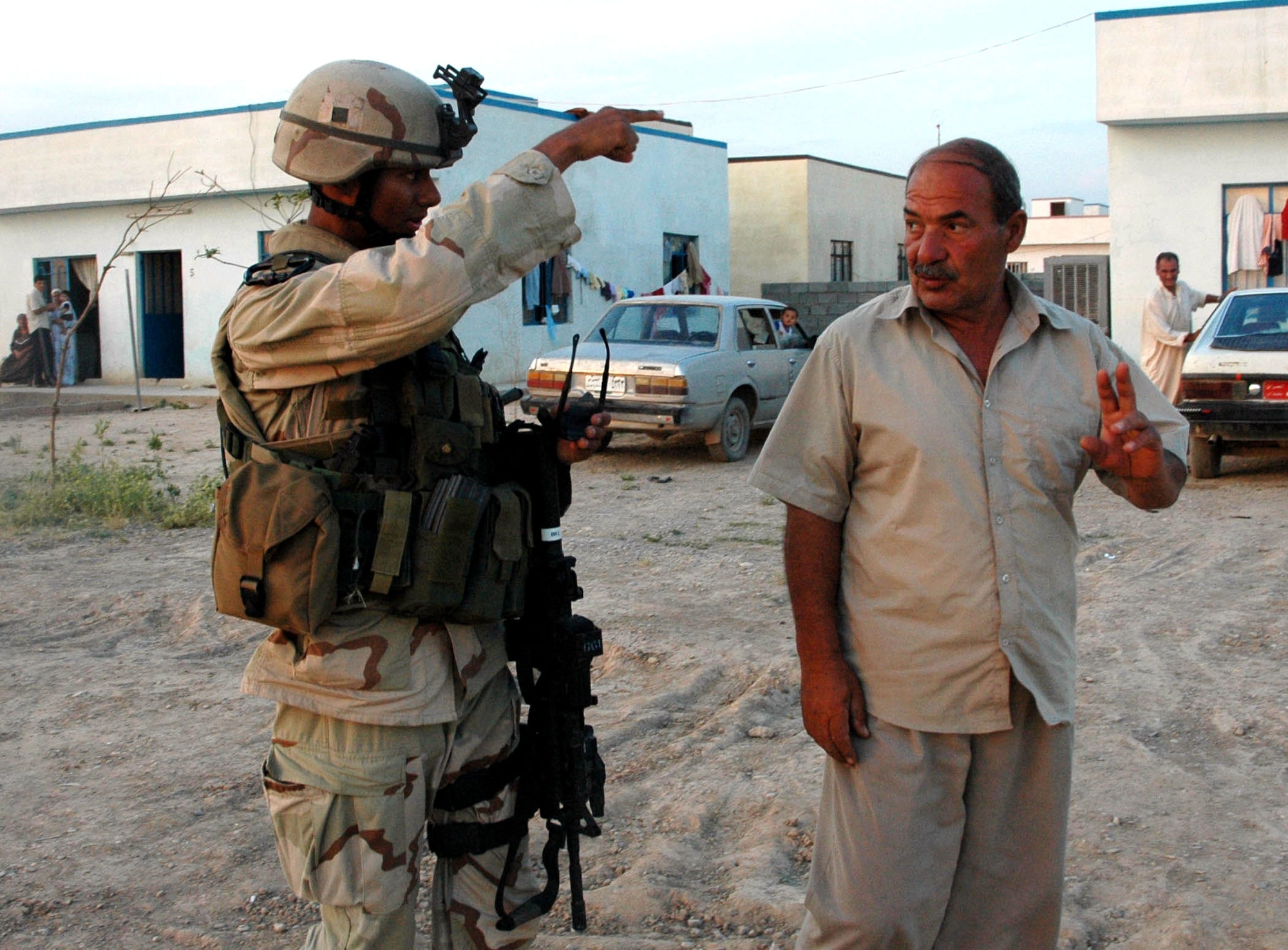 First Lt. Justin Banez talks with a resident of New Belawah, Iraq, during a patrol on Monday, May 22, 2006. Airmen of the 506th Expeditionary Security Forces Squadron conduct patrols in the base defense zone of Kirkuk. Getting to know the locals helps the Airmen assure freedom of movement for coalition forces. (U.S. Air Force photo/Staff Sgt. Kristina Barrett)