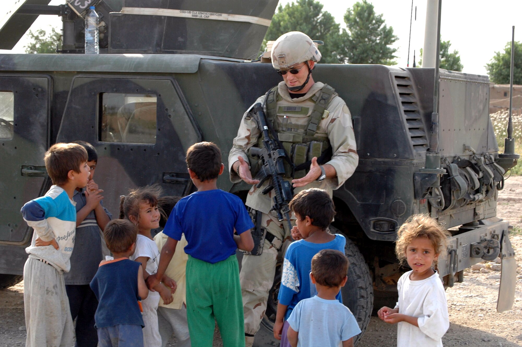 Airman Andrew Smith gets to know the local children in the village of Dibik Tappah during a patrol near Kirkuk Air Base, Iraq, on Monday, May 22, 2006. Airman Smith is with the 506th Expeditionary Security Forces Squadron and is deployed from Moody Air Force Base, Ga. (U.S. Air Force photo/Staff Sgt. Kristina Barrett)