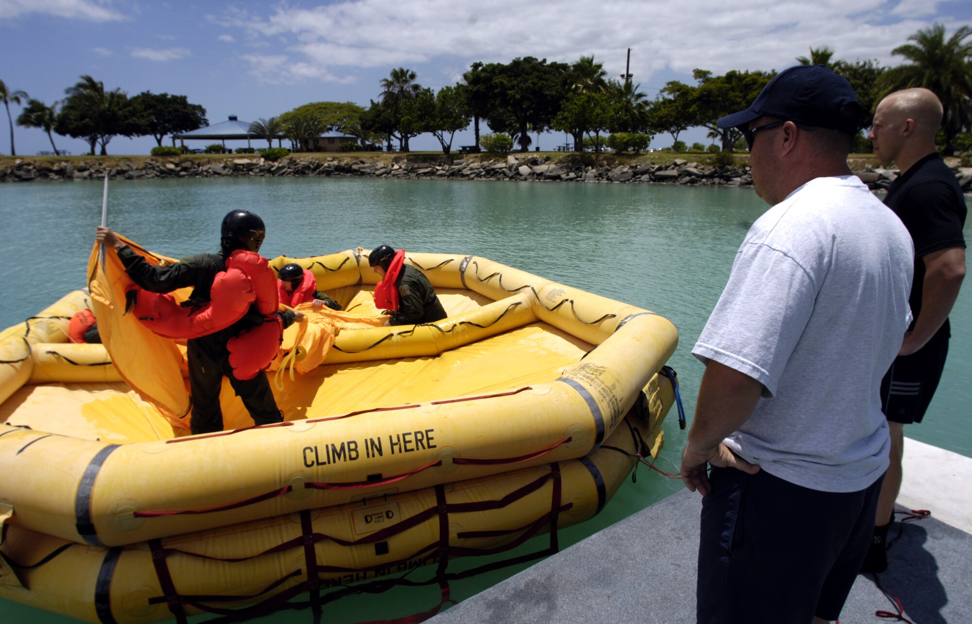 060501-F-2034C-022
Staff Sgt Chris Ferguson and Staff Sgt. Matt Magnussen watch students put up a canopy on a 46-man lift raft May 1, 2006 during a water survival refresher course being held at the Hickam Harbor on Hickam Air Force Base, Hawaii. The course provides hands on realistic training for aircrew members, which covers subjects on survival equipment, life raft familiarization, parachute disentanglement and rescue techniques. SSgt Ferguson is the SERE (survival evasion resistance escape) instructor and SSgt Magnussen is the life support instructor from the 15th Operations Support Squadron. Both Sgt.?s are responsible for training all active duty and Air National Guard aircrews on Hickam. (U.S. Air Force photo by Tech. Sgt. Shane A. Cuomo)
