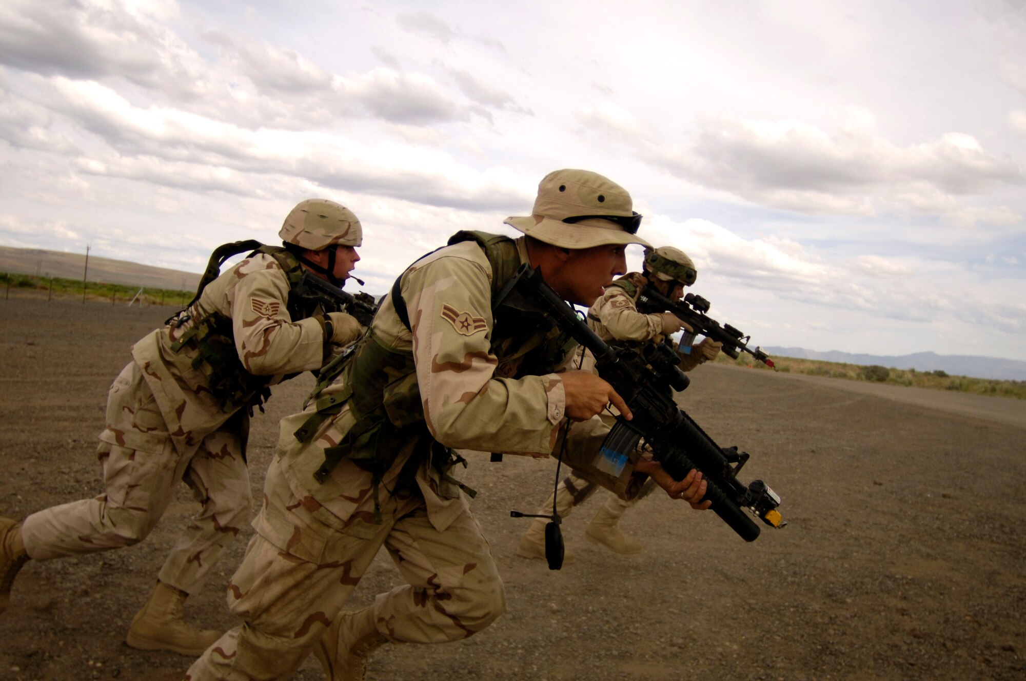 Security forces Airmen with the 615th Contingency Response Wing at Travis Air Force Base, Calif., rush toward a simulated threat during Lightning Fury, an airfield seizure exercise held at Amedee Field in Herlong, Calif., on Saturday, May 20, 2006. (U.S. Air Force photo/Staff Sgt. James L. Harper Jr.)