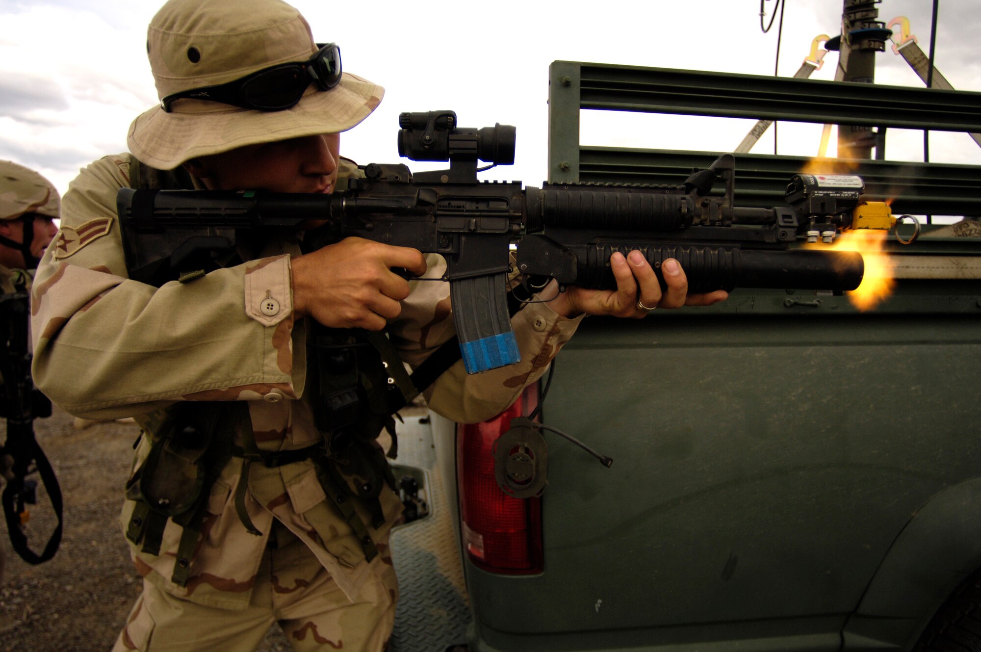 Airman 1st Class Jason Lompre returns fire during a simulated fight with opposing forces during Lightning Fury, an airfield seizure exercise at Amedee Field in Herlong, Calif., on Saturday, May 20, 2006. Airman Lompre is with the 615th Contingency Response Wing at Travis Air Force Base, Calif. (U.S. Air Force photo/Staff Sgt. James L. Harper Jr.)