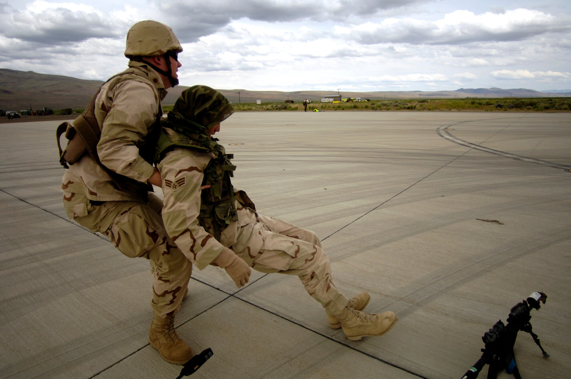 Maj. Christopher Bird rescues a "wounded" security forces Airman during Lightning Fury, an airfield seizure exercise held at Amedee Field in Herlong, Calif., on Saturday, May 20, 2006. Major Bird is with the 60th Medical Group at Travis Air Force Base, Calif. (U.S. Air Force photo/Staff Sgt. James L. Harper Jr.) 
