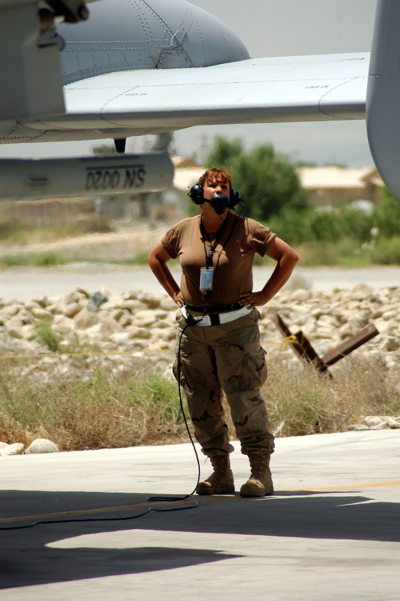 BAGRAM AIRFIELD, Afghanistan -- Staff Sgt. Tammy Kjos talks, an A-10 crew chief and Air Force Reservist deployed here from the 442nd Fighter Wing, Whiteman Air Force Base, Mo., talks to A-10 pilot, Capt. Thomas Kanewske via intercom on the status of his flight control check prior to taking off on a combat mission for Operation Enduring Freedom.  (Photo By Maj. David Kurle)