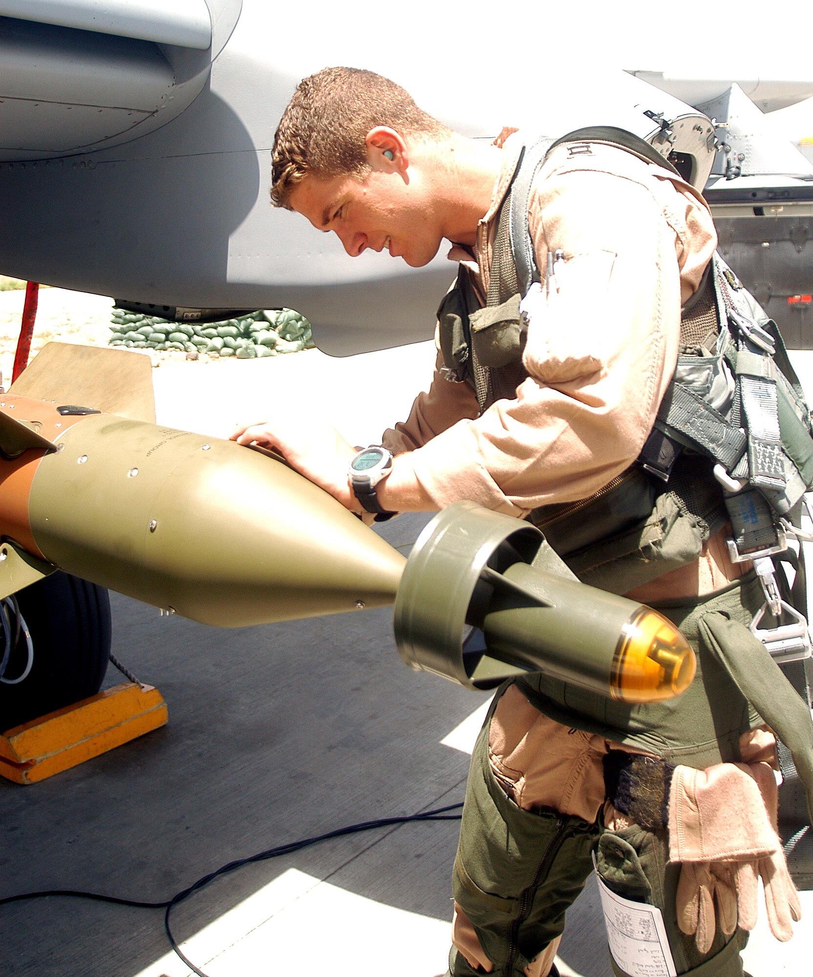 Capt. Thomas Kanewske inspects the ordnance on an A-10 Thunderbolt II before taking off on a combat mission from Bagram Air Base, Afghanistan, on Tuesday, May 23, 2006.  Captain Kanewske is deployed to Bagram from Spangdahlem Air Base, Germany, in support of Operation Enduring Freedom. (U.S. Air Force photo/Maj. David Kurle)
