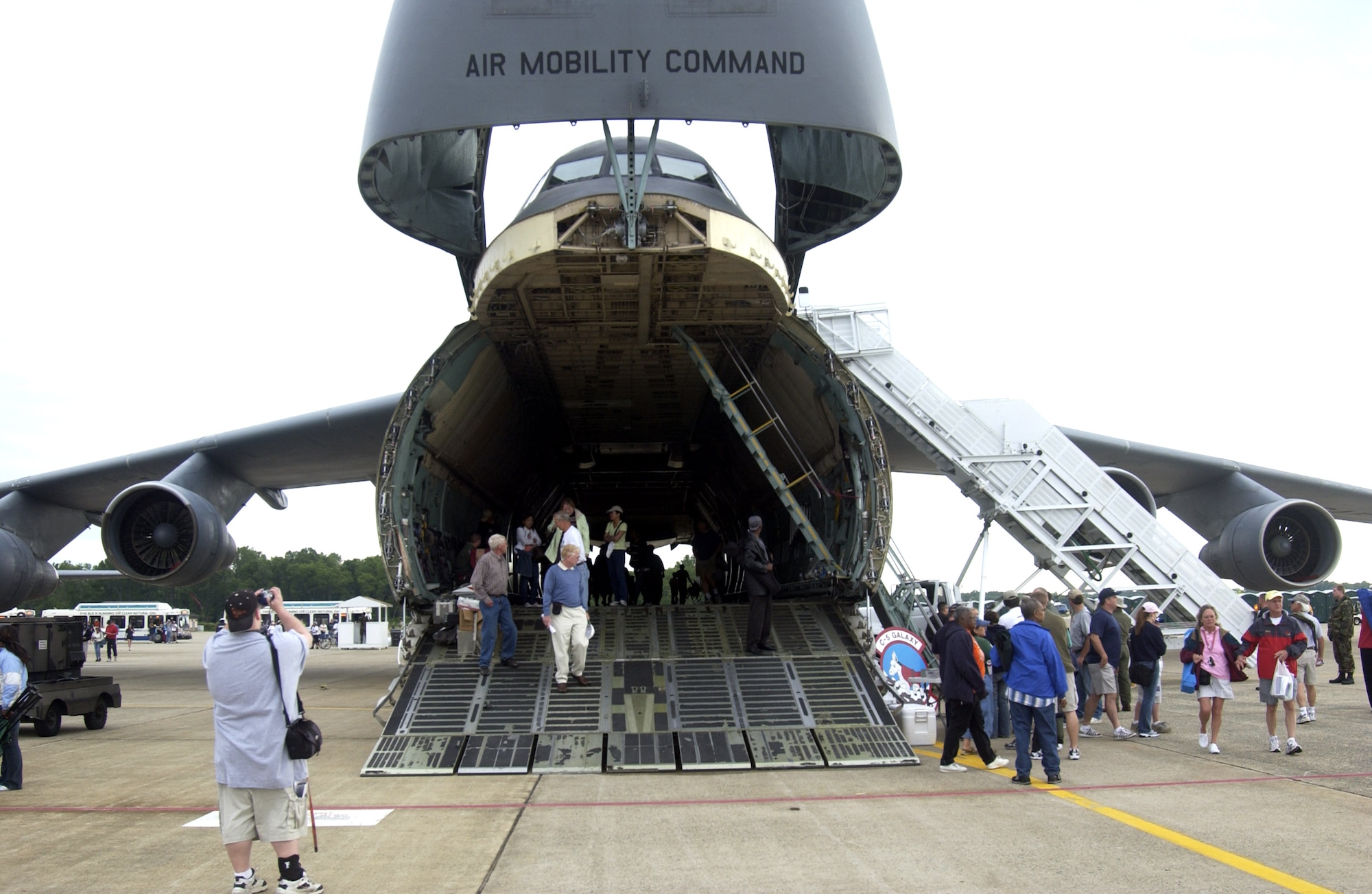 A C-5 Galaxy from Travis Air Force Base, Calif., attracts visitors during the 56th annual Department of Defense 2006 Joint Service Open House at Andrews Air Force Base, Md., on Saturday, May 20, 2006. The three-day event highlighted American aviators, aircraft and technology. (U.S. Air Force photo/Airman 1st Class Patrick D. Thom)