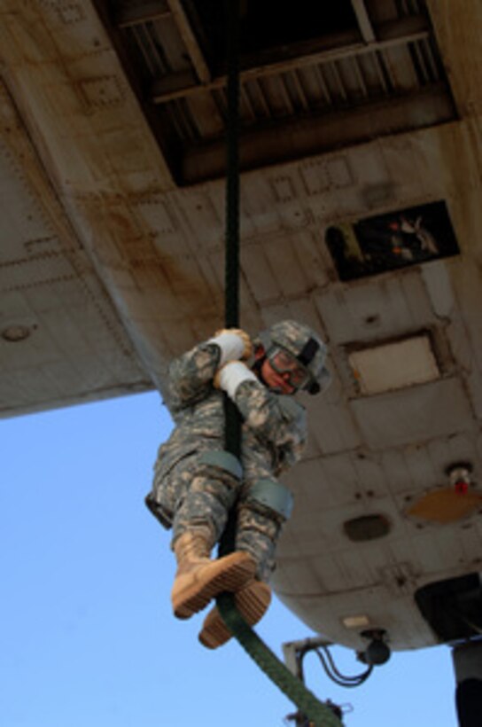 A U.S. Army soldier with the 1st Brigade, 29th Infantry Division fast ropes from a helicopter during a rapid-insertion exercise in Djibouti City, Djibouti, on May 18, 2006. 