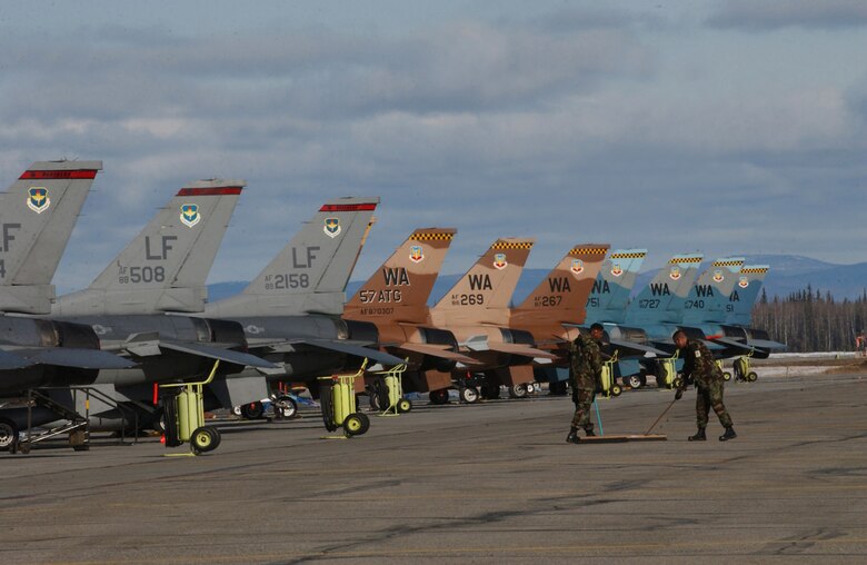 EIELSON AIR FORCE BASE, Alaska - Airmen sweep up after the "Aggressors" on the flight line here for RED FLAG - Alaska.  The 64th Aggressor Squadron, Nellis AFB, Nev. is the first-ever dedicated aggressor unit to play in the Alaska wargame and will be joined by the 63rd Fighter Squadron, Luke AFB, Ariz., as the "hostile force" for the exercise.  More than 80 aircraft and 1500 personnel are participating in the excercise formerly known as Cope Thunder.  Red Flag - Alaska runs through May 5.  (US Air Force Photo by TSgt Julie Avey)