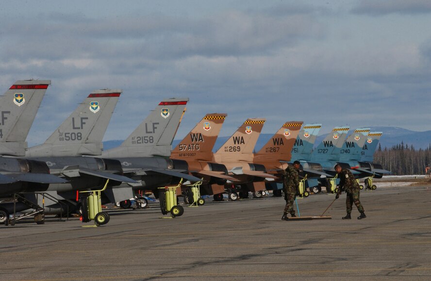 EIELSON AIR FORCE BASE, Alaska - Airmen sweep up after the "Aggressors" on the flight line here for RED FLAG - Alaska.  The 64th Aggressor Squadron, Nellis AFB, Nev. is the first-ever dedicated aggressor unit to play in the Alaska wargame and will be joined by the 63rd Fighter Squadron, Luke AFB, Ariz., as the "hostile force" for the exercise.  More than 80 aircraft and 1500 personnel are participating in the excercise formerly known as Cope Thunder.  Red Flag - Alaska runs through May 5.  (US Air Force Photo by TSgt Julie Avey)