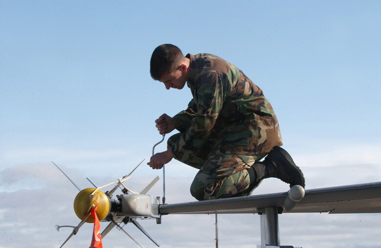 EIELSON AIR FORCE BASE, Alaska - Airman First Class Aaron  Hasenauer, Crew Chief with the 63rd Aircraft Maintenance Unit, Luke Air Force Base, tightens the flaperon screws on a 63rd Fighter Squadron's  F-16 Fighting Falcon at Red Flag Alaska.  The unit is playing the role of "hostile" or "red air" forces alongside the first-ever dedicated aggressor unit to play in the Air Force-level exercise. (US Air Force Photo by TSgt Julie Avey)                                 