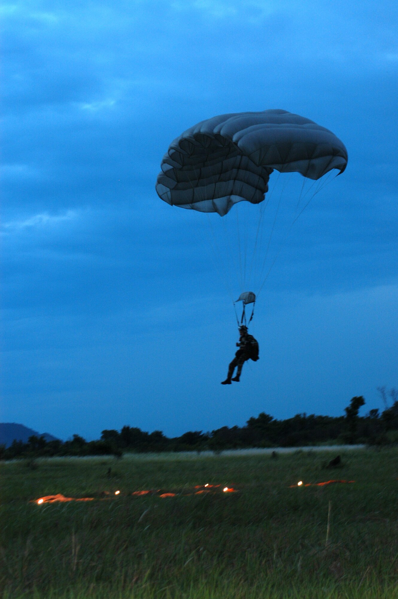 A jumper from the 320th Special Tactics Squadron hits his mark during a high altitude low opening jump from an MC-130 in U-Taphao, Thailand, during Cobra Gold 2006.
