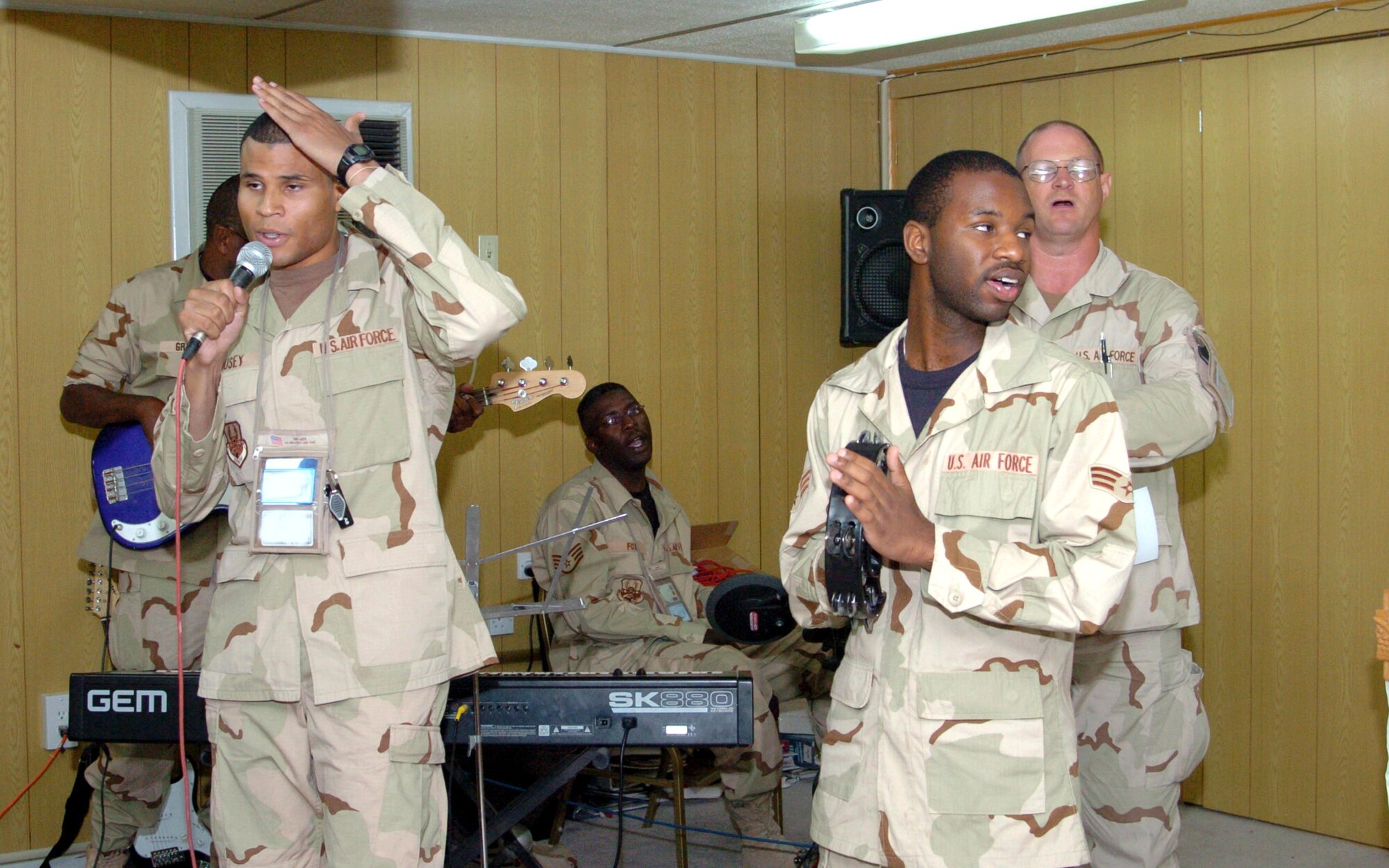 The chapel praise team leads the congregation in song during a Protestant service at the 380th Air Expeditionary Wing's chapel in Southwest Asia on Sunday, May 21, 2006.  The team includes Senior Airman Toby Housey, 380th Expeditionary Mission Support Group (microphone); Master Sgt. Stanley Grant, 380th Expeditionary Civil Engineer Squadron (bass); Staff Sgt. Anthony Fox, 380th ECES (drums); Senior Airman Arland Fludd, 380th Expeditionary Logistics Readiness Squadron (tambourine); and Master Sgt. James Polasky, 380th ECES. (U.S. Air Force photo/Master Sgt. Stanley Coleman) 