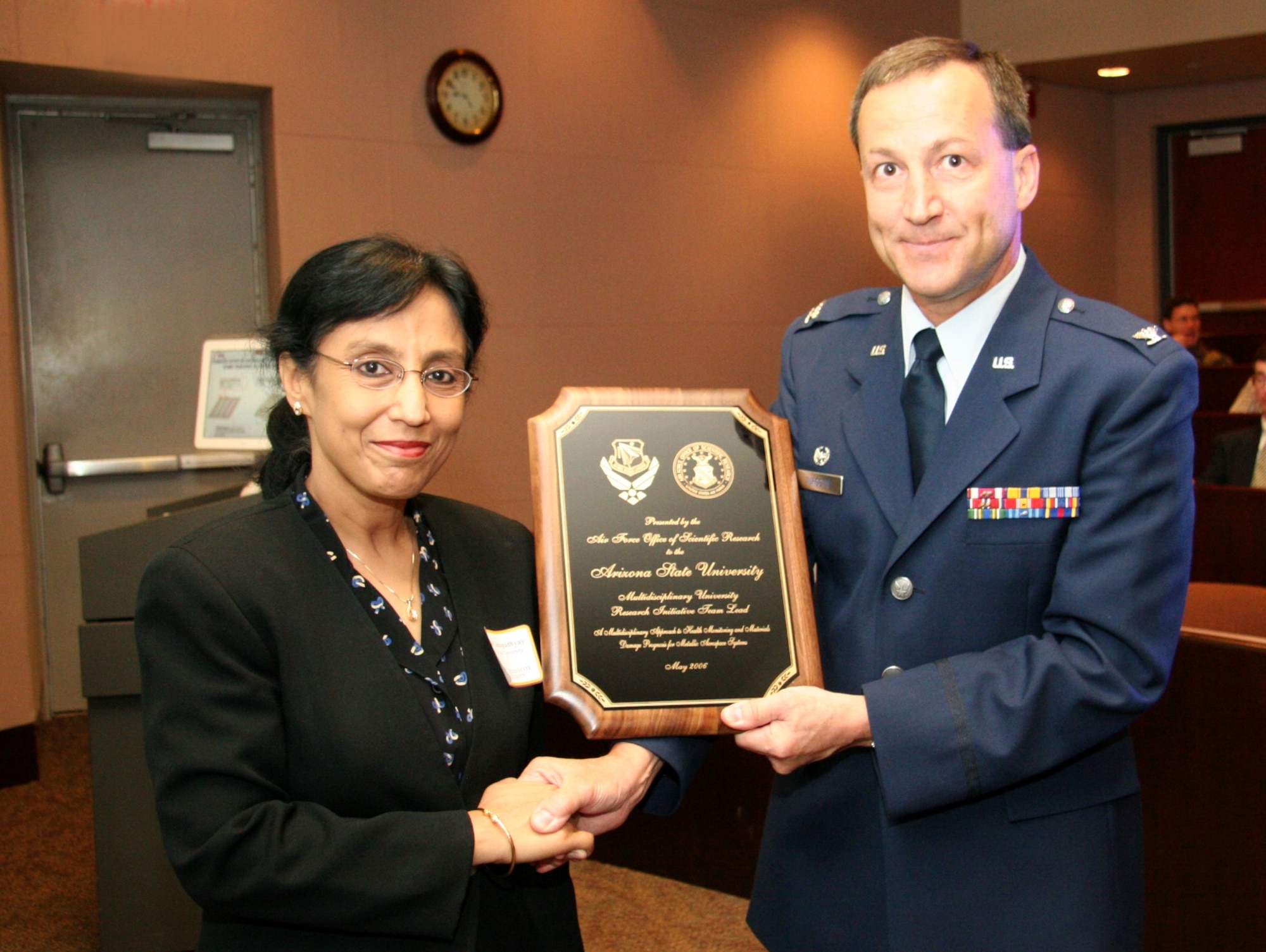 PHOENIX— Col. Jeff Turcotte, Deputy Director at the Air Force Office of Scientific Research, presents a plaque to Prof. Aditi Chattopadhyay, Principal Investigator of the aerospace research project at the Ira A. Fulton School of Engineering at Arizona State University, supported by an $8.6 million Department of Defense Multidisciplinary University Research Initiative program grant. (Arizona State University photo by Kenneth Sweat)

