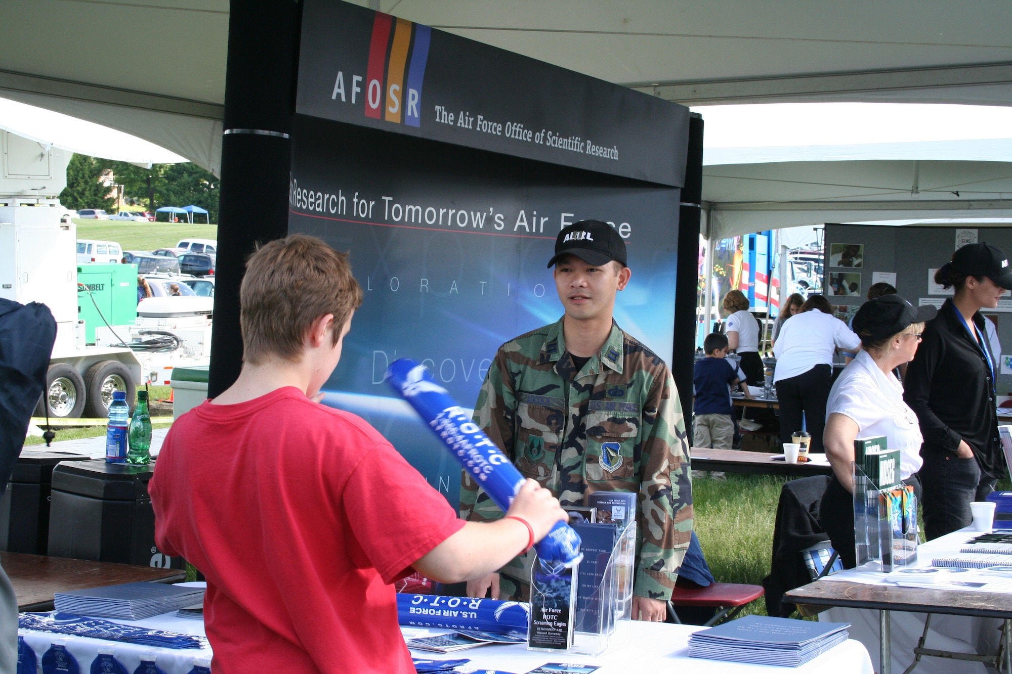 ARLINGTON, Va.— AFOSR Deputy Director of Policy and Integration, Capt. Dan Adcock, talks with a visitor to the AFOSR information booth May 20 at Team America Rocketry Challenge, The Plains, Va.  Hundreds of students, parents, and teachers visited the booth throughout the day.  (Air Force photo by Erin Crawley)
