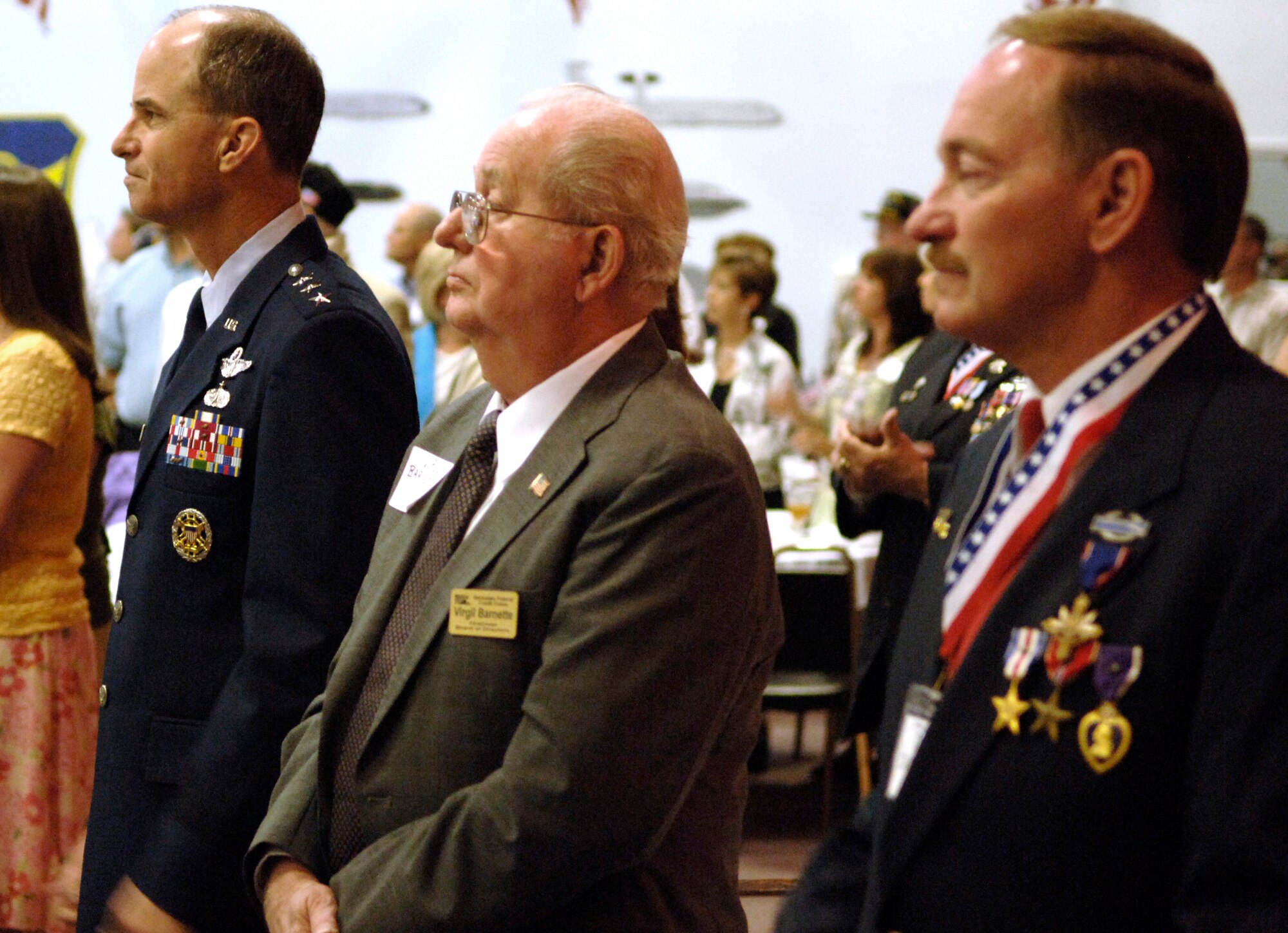 (From left) Lt. Gen. Kevin P. Chilton, retired Chief Master Sgt. Virgil Barnett and retired Army Maj. Ron Chatelain stand in honor of the 82 former prisoners of war and 250 Purple Heart recipients at the 2006 Former POW/Purple Heart Luncheon at  Barksdale Air Force Base, La, on Saturday, May 20, 2006.  General Chilton, 8th Air Force commander, was the keynote speaker. (U.S. Air Force photo/Master Sgt. Michael A. Kaplan) 
