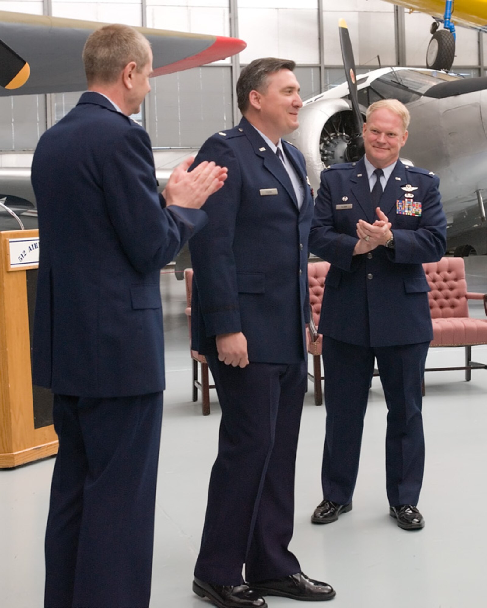512th Airlift Wing Vice Commander Col. David H. Wuest, left, and outgoing 512th Operations Group Commander Col. Don Sloan, right, welcome the 512th Operations Group's new commander, Lt. Col. Darrell Young, to the 512th AW at the 512th OG Change of Command May 7 at the Air Mobility Command Museum.