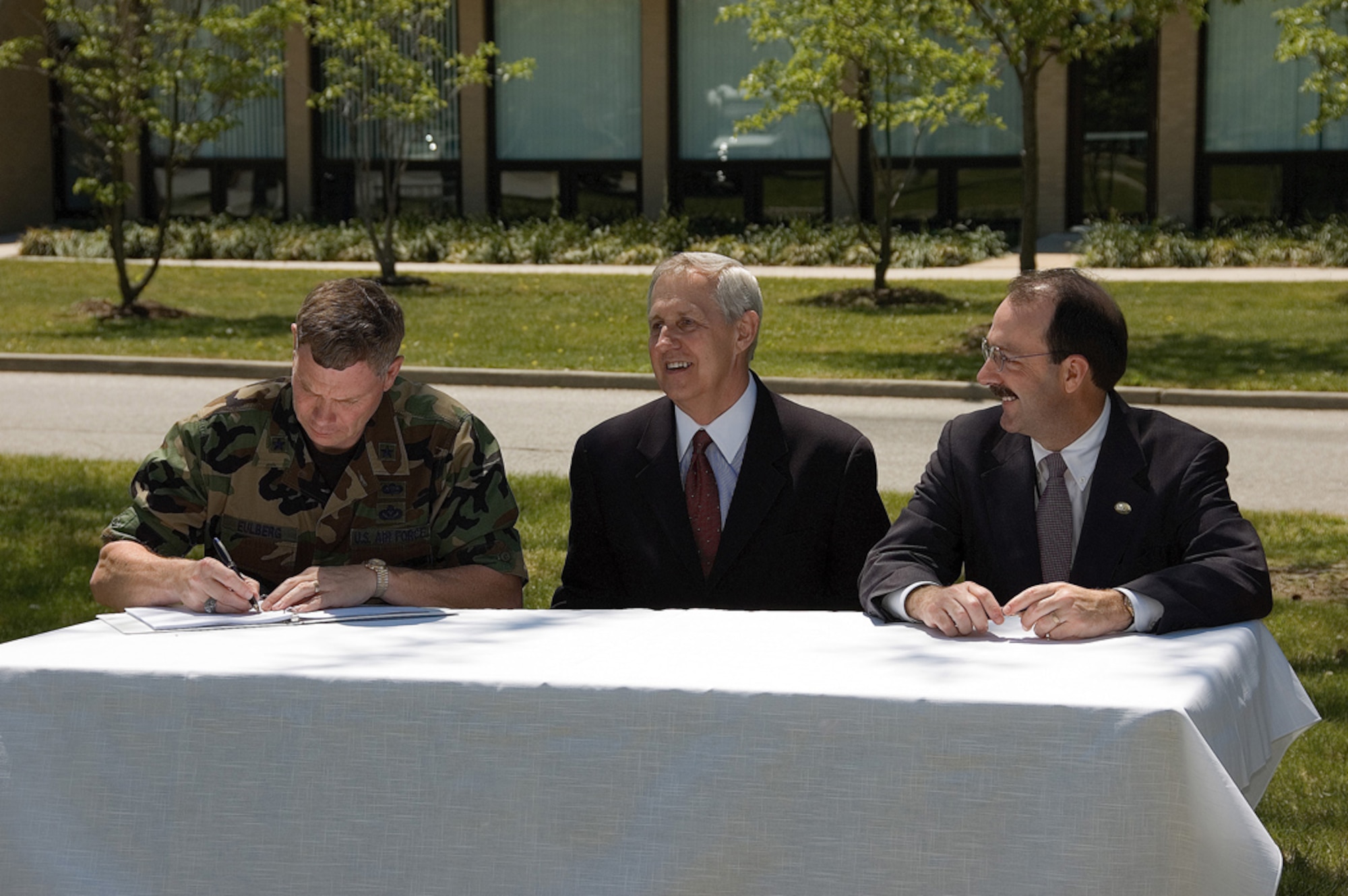 (Left to right) Brig. Gen. Del Eulberg, Air Mobility Command director of Installations and Mission Support, signs the record of decision for two contaminant release sites along with William Wisniewski, Environmental Protection Agency deputy regional administrator, and James Werner, Delaware Department of Natural Resources and Environmental Control director of Air and Waste Management, here May 12. (U.S. Air Force photo by Roland Balik)