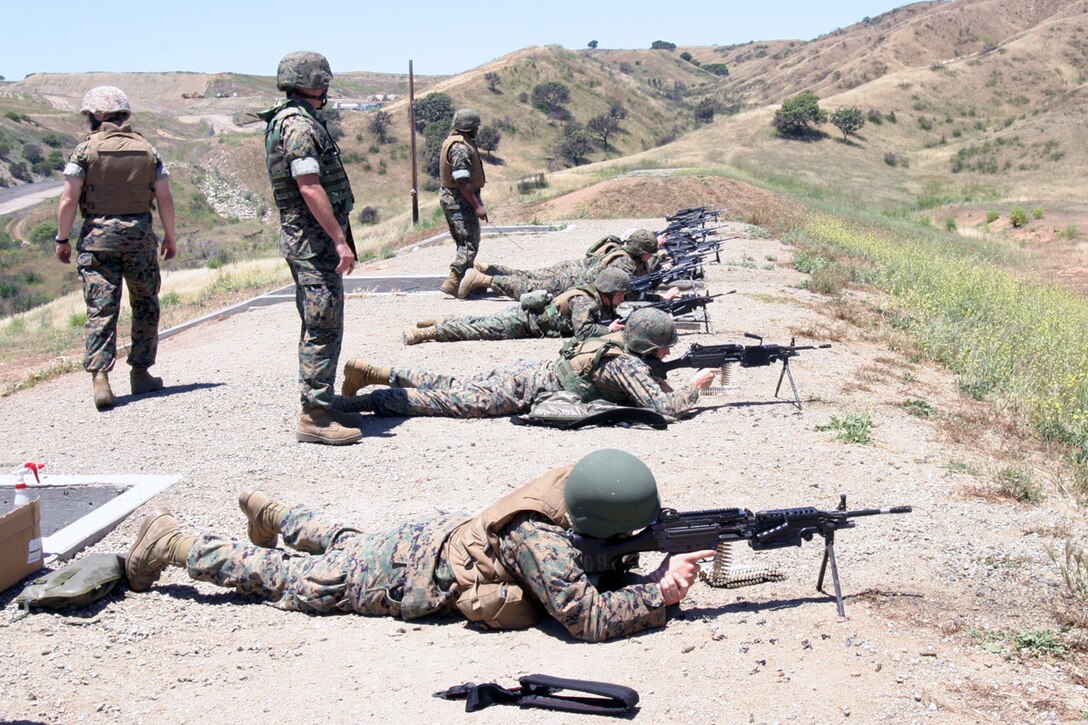 CAMP PENDLETON Calif. (May 24, 2006) - Marines with the 15th Marine Expeditionary Unit fire at their targets with M249 squad automatic weapons during a live fire exercise at Range 223 here. 15th MEU Marines are participating in the training to familiarize themselves with the weapon, and become more efficient in its maintenance and operation.