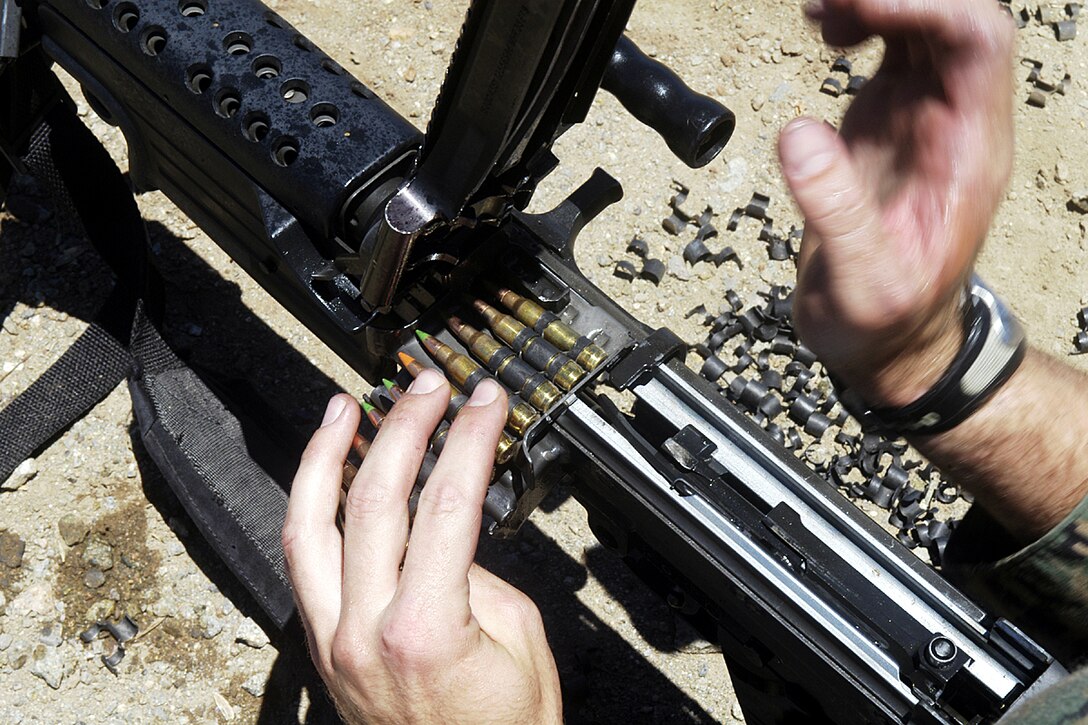Camp Pendleton, Calif. - A Marine from the 15th Marine Expedtionary Unit loads a 20 round belt of ammunition into his M249 Squad Automatic Weapon. The course was given to Marines from the Command Element of the 15th MEU in an effort to prepare them for duty as SAW-gunners while a member of a security element. (Official USMC photo by Staff Sgt. T.G. Kessler) (Released)