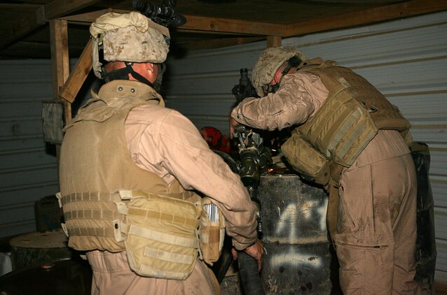 Marines with Combat Logistics Company 115 refill fuel containers at an American outpost near the city of Fallujah, May 24, 2006. The company, along with the rest of Combat Logistics Battalion 5, serves as a logistical support unit in the Al Anbar Province, supporting American and Iraqi forces operating here. On major re-supply convoys, CLC 115 will deliver food, water, fuel and other equipment or supplies to multiple locations in one trip outside the security of Camp Fallujah.