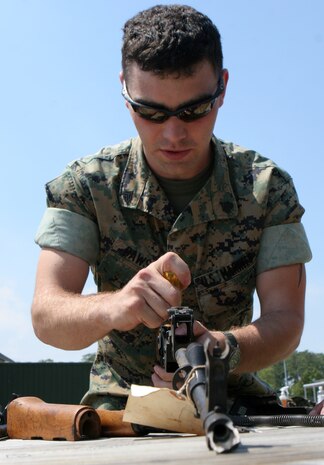 MARINE CORPS BASE CAMP LEJEUNE, N.C. -- A Marine from Headquarters and Service Battalion, 2nd MLG puts down the company guidon after a long run. Marines after long physical training sessions should hydrate to prevent heat injury.