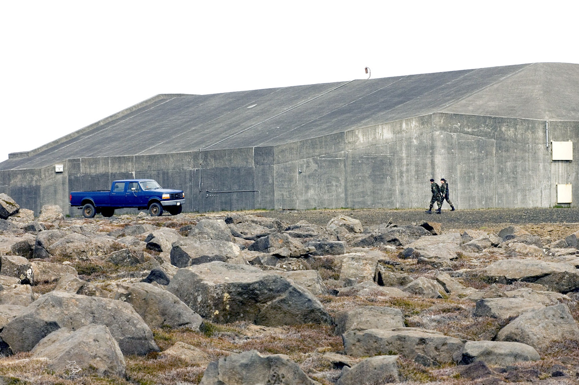 Staff Sgt. Ryan Blume and Airman 1st Class Alisha Torgerson check a protected aircraft shelter at Naval Air Station Keflavik, Iceland, on Monday, May 22, 2006. Airmen and Sailors are reducing operations after more than 50 years of U.S. presence at the base. Sergeant Blume, from Nealsville, Wis., and Airman Torgerson, from Oxnard, Calif., are security force Airmen with Keflavik's 85th Security Forces Squadron. (U.S. Air Force photo/Master Sgt. John E. Lasky)