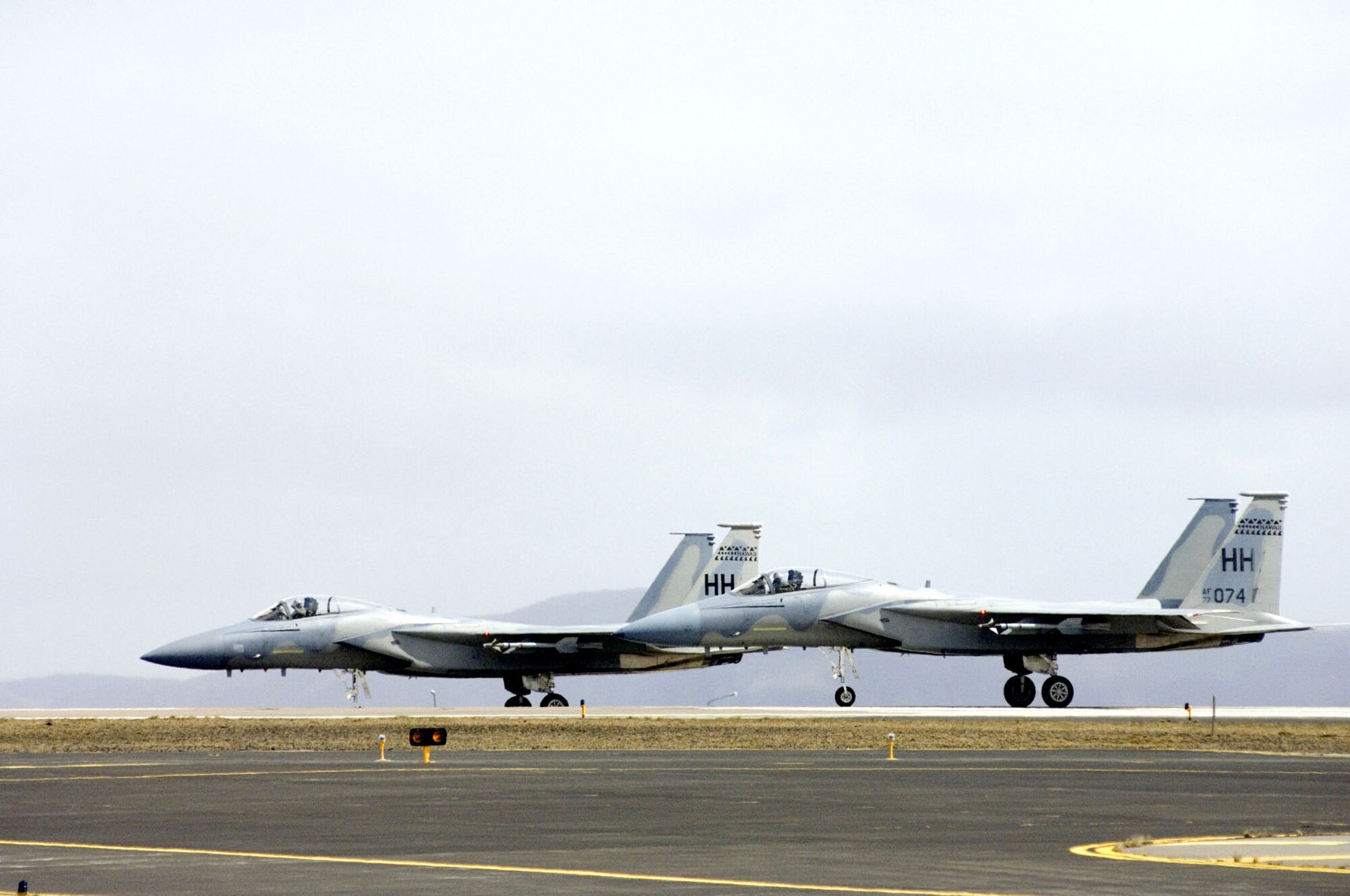 F-15 Eagles wait to take off from Naval Air Station Keflavik, Iceland, on Monday, May 22, 2006. Airmen and Sailors are reducing operations after more than 50 years of U.S. presence at the base. The F-15s and crews are from the Hawaii Air National Guard's 154th Fighter Wing at Hickam Air Force Base. (U.S. Air Force photo/Master Sgt. John E. Lasky) 