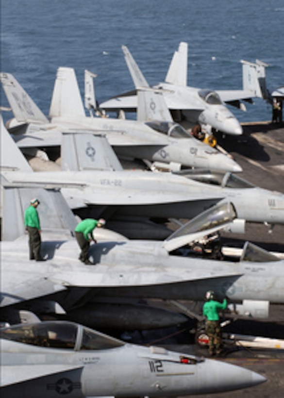 Sailors assigned to Strike Fighter Squadron 22 perform routine maintenance on an F/A-18E Super Hornet aircraft on the flight deck of the aircraft carrier USS Ronald Reagan (CVN 76) as the ship operates in the Persian Gulf on May 21, 2006. Reagan and Carrier Air Wing 14 are conducting maritime security operations in the region. 