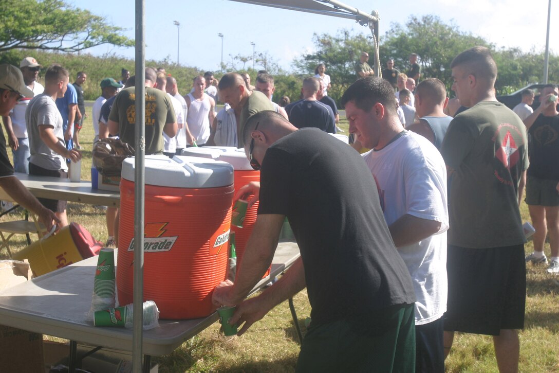 Service members grab a drink of water May 25 after running in the 101 Days of Summer fun run. Though the summer months have passed it is still important to remember to hydrate to avoid heat exhaustion, heat stroke, and death.